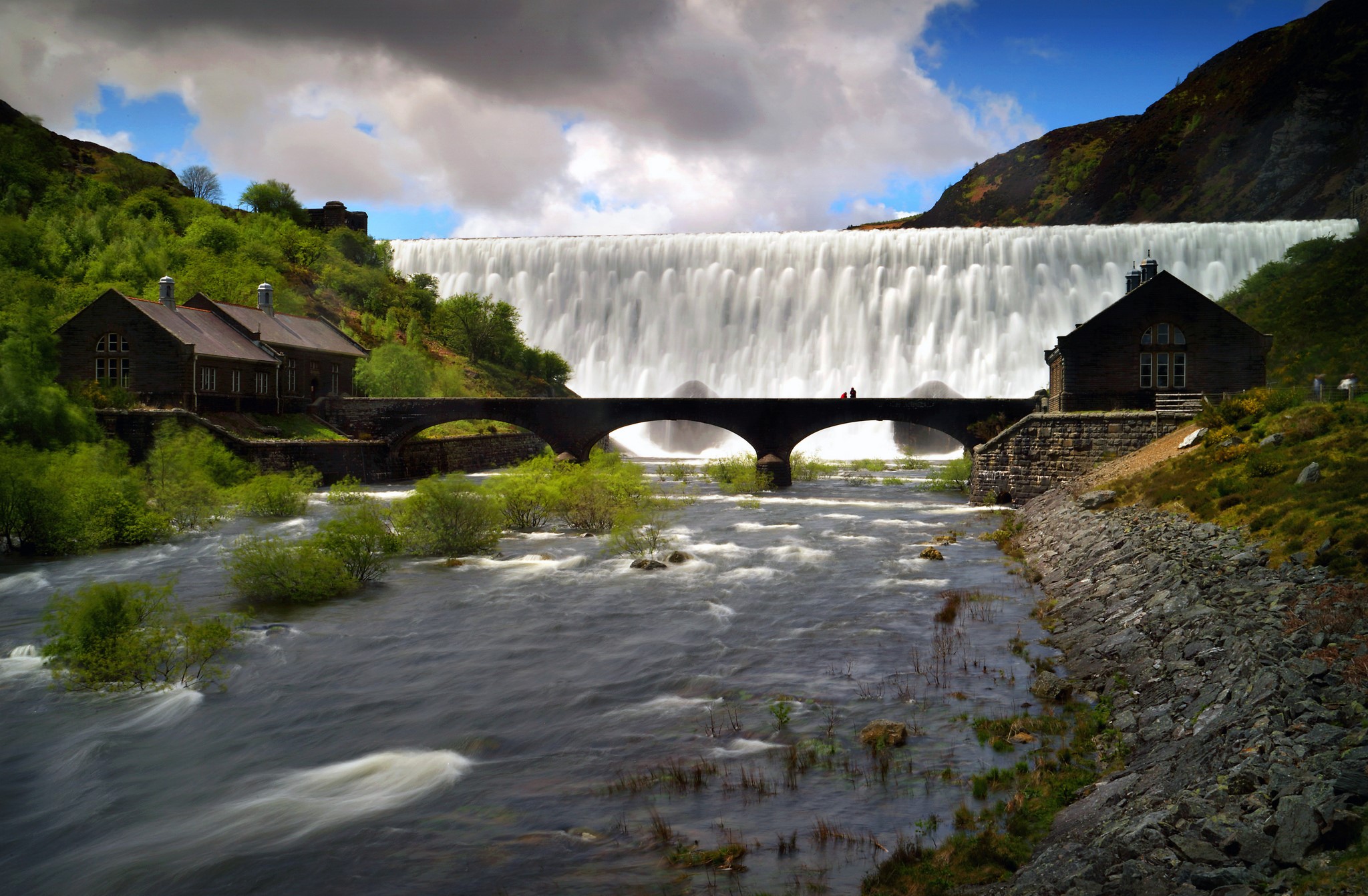Waterfall and bridge with houses and river HD Wallpaper