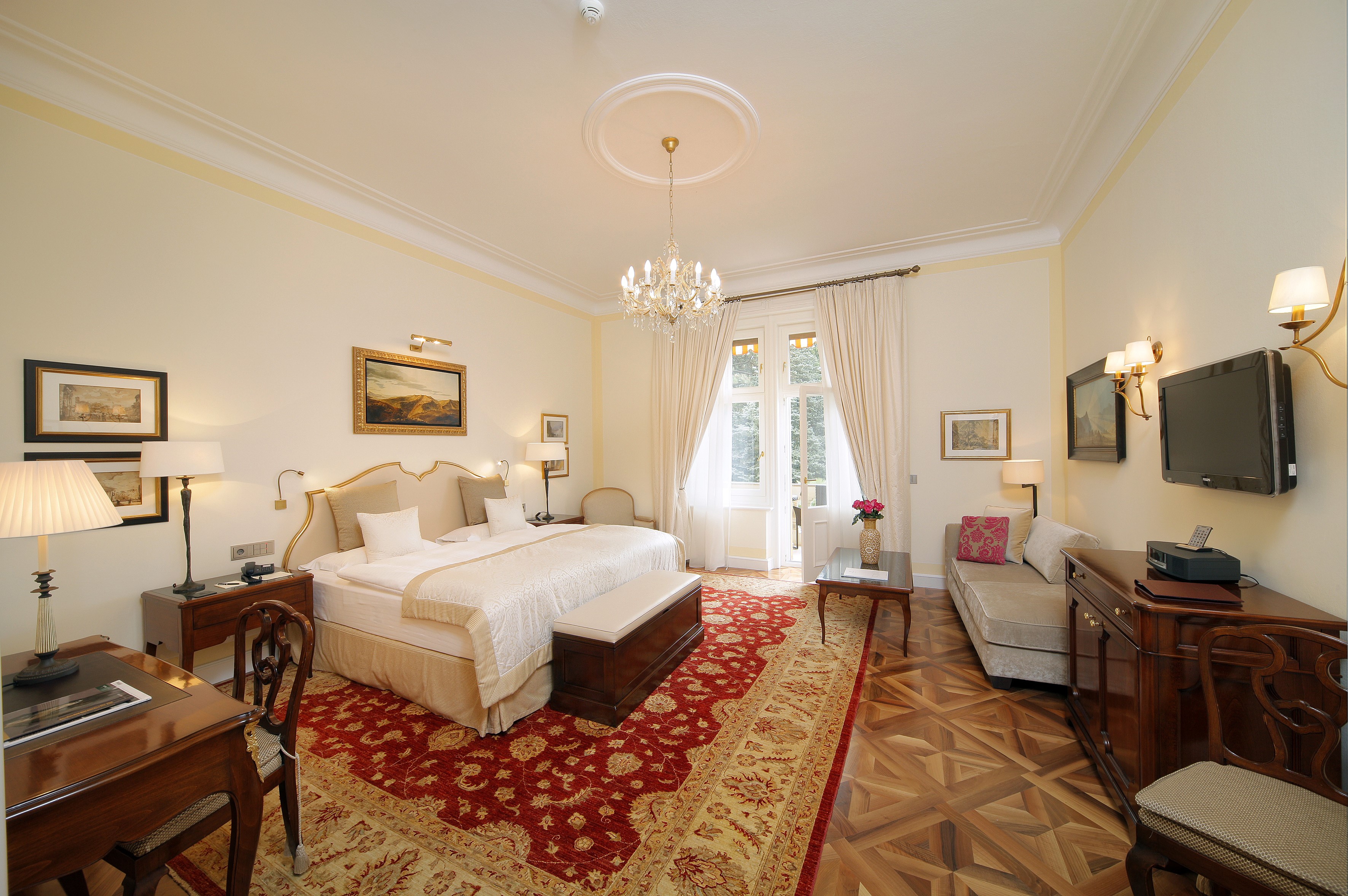 Luxury Hotel Bedroom with Chandelier and Antique Furniture HD Wallpaper