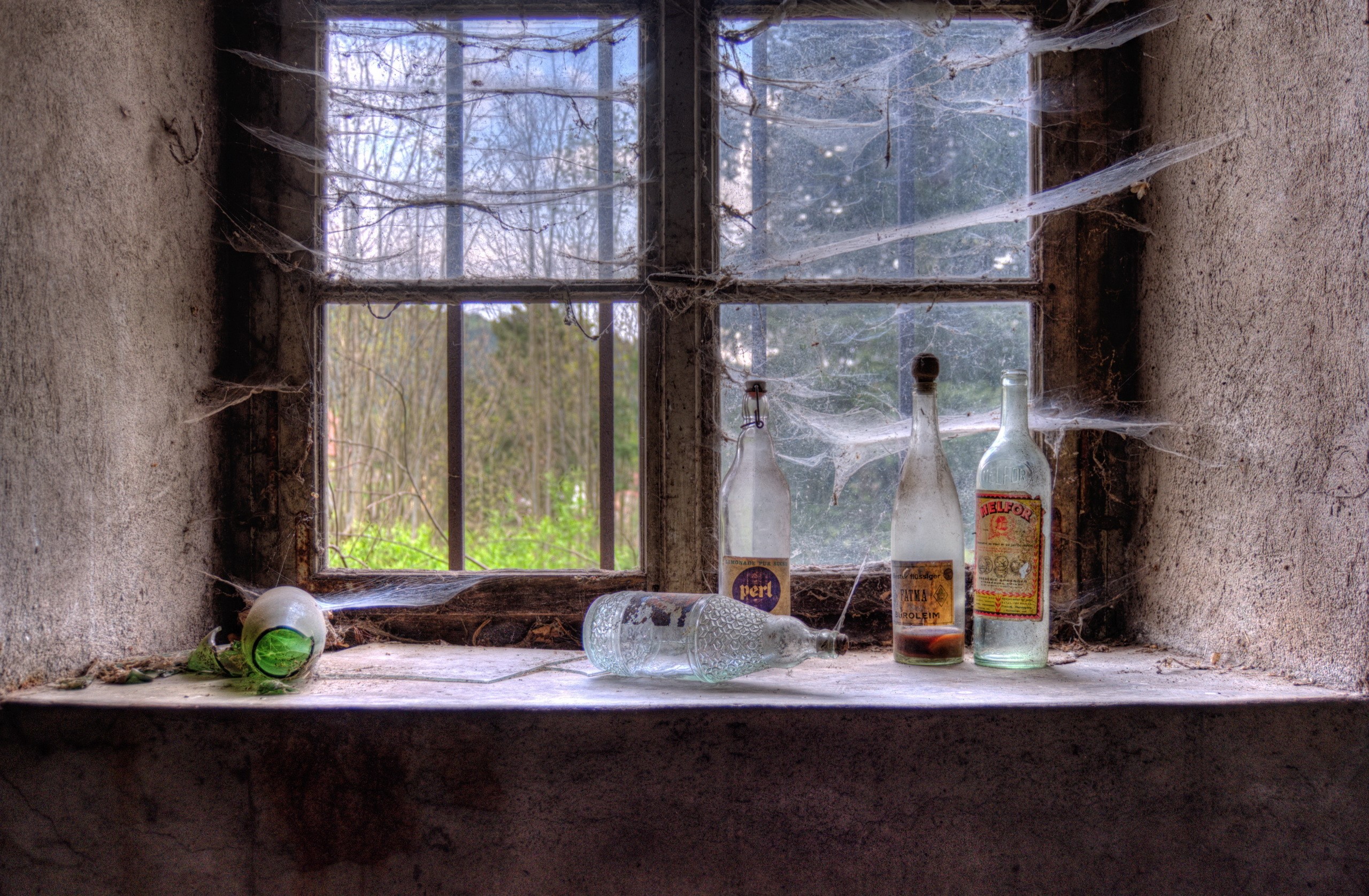 Bottles and spider webs on a windowsill HD Wallpaper