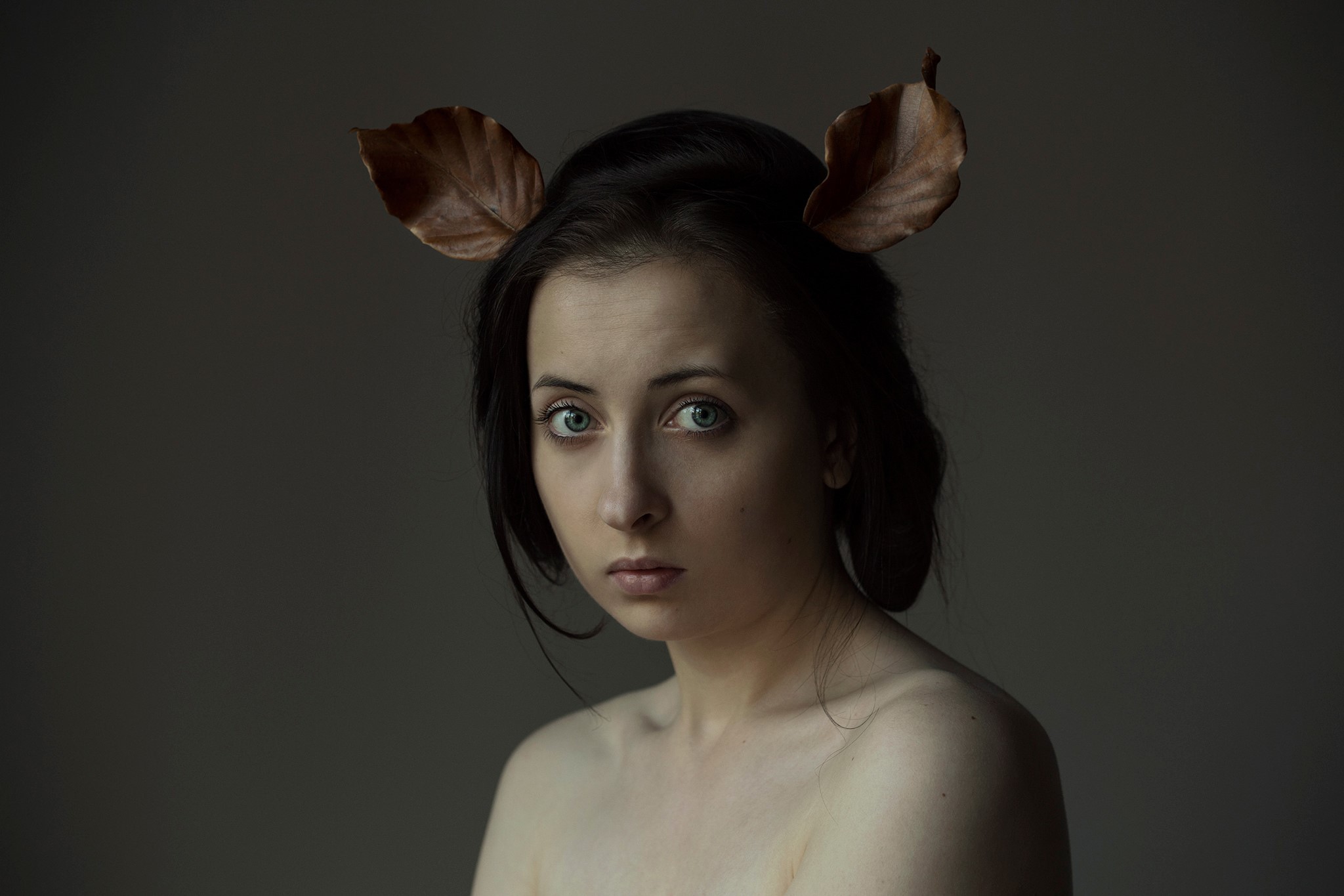 Woman with leaves as ears looking at the camera HD Wallpaper