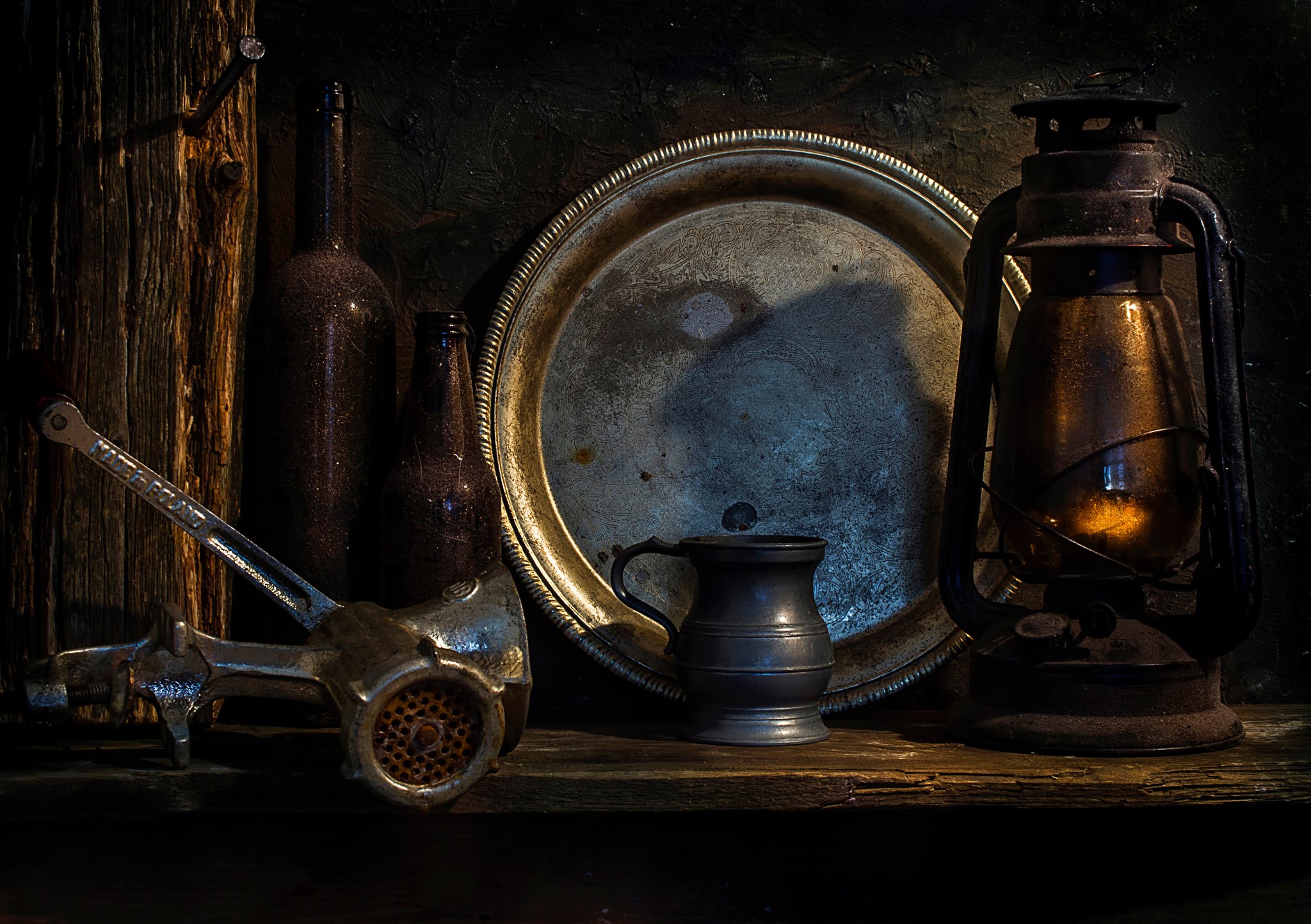 Still life with meat grinder, bottles, tray, and lantern HD Wallpaper