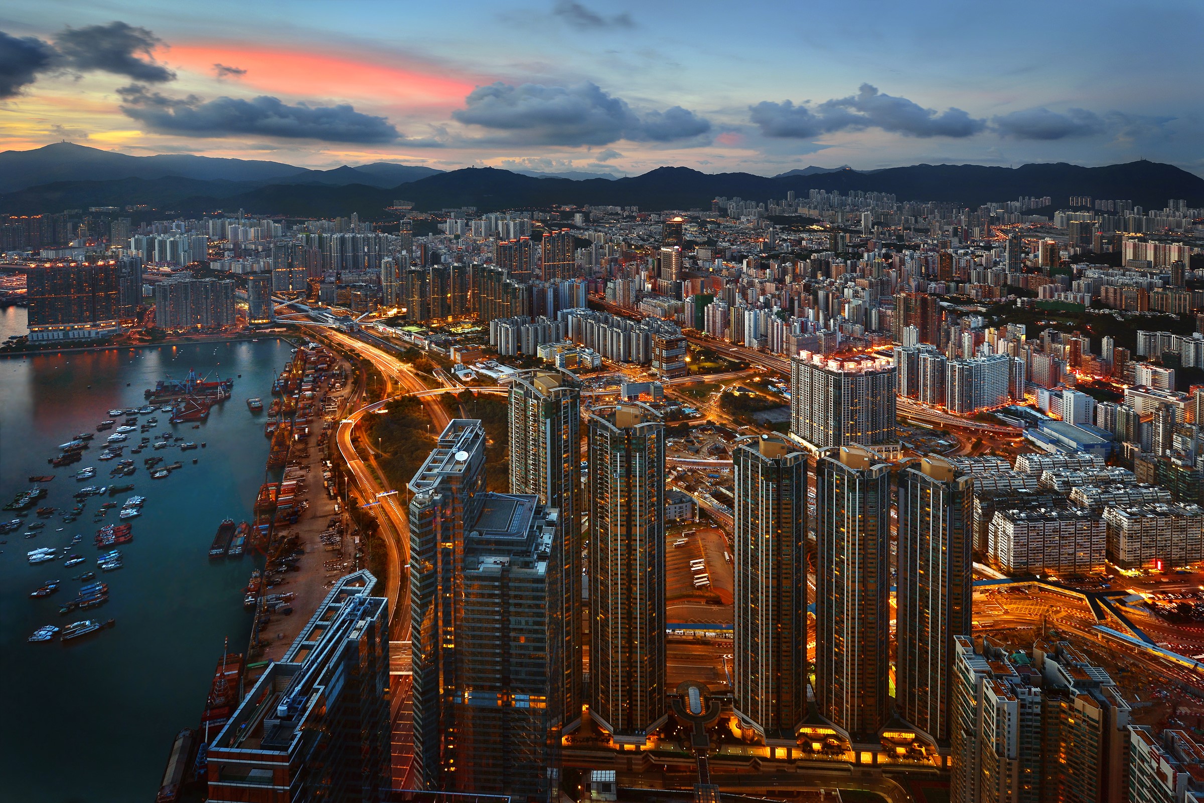 Hong Kong cityscape with harbor and mountains at dusk HD Wallpaper