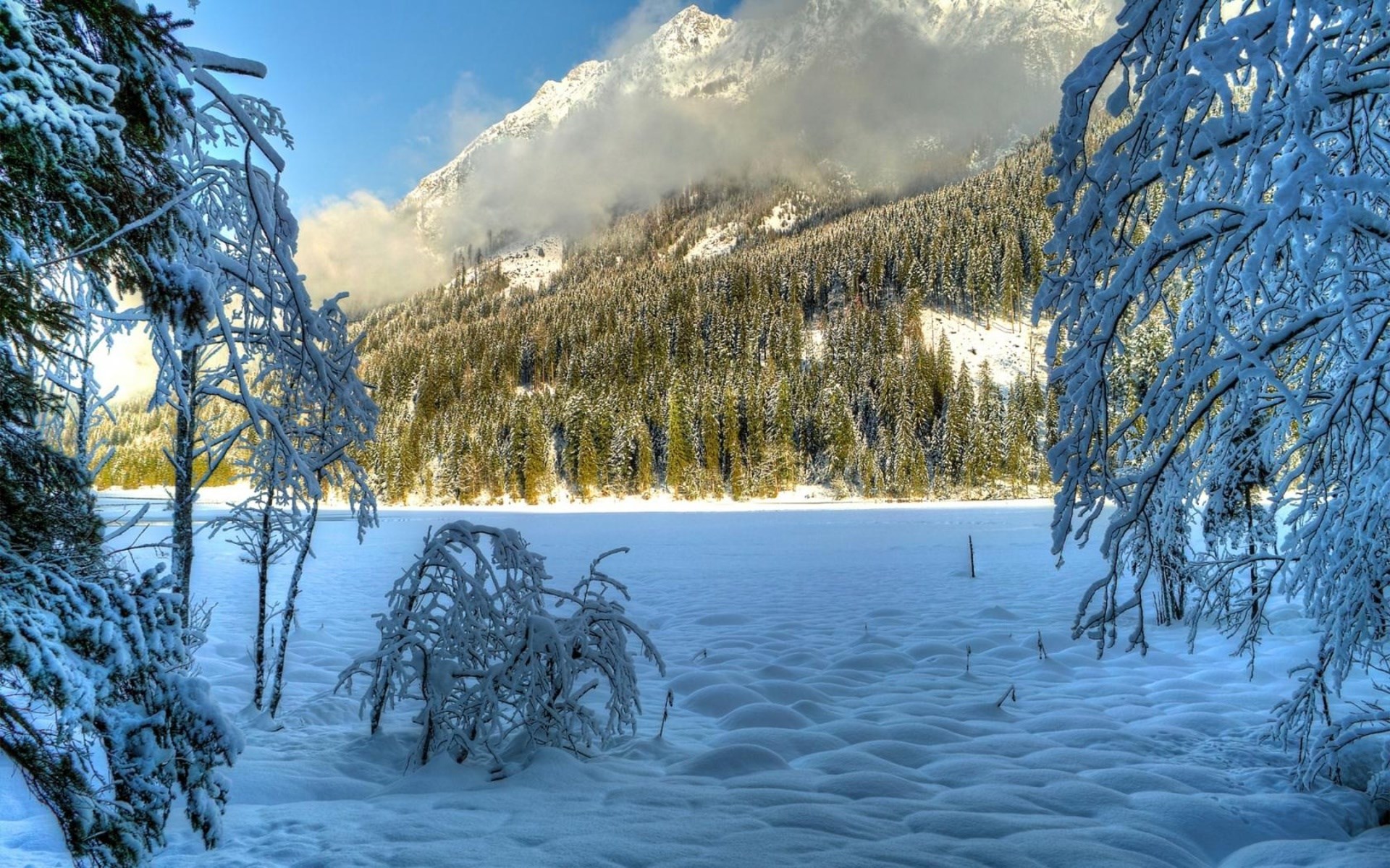Snowy mountain landscape with frozen lake and trees HD Wallpaper