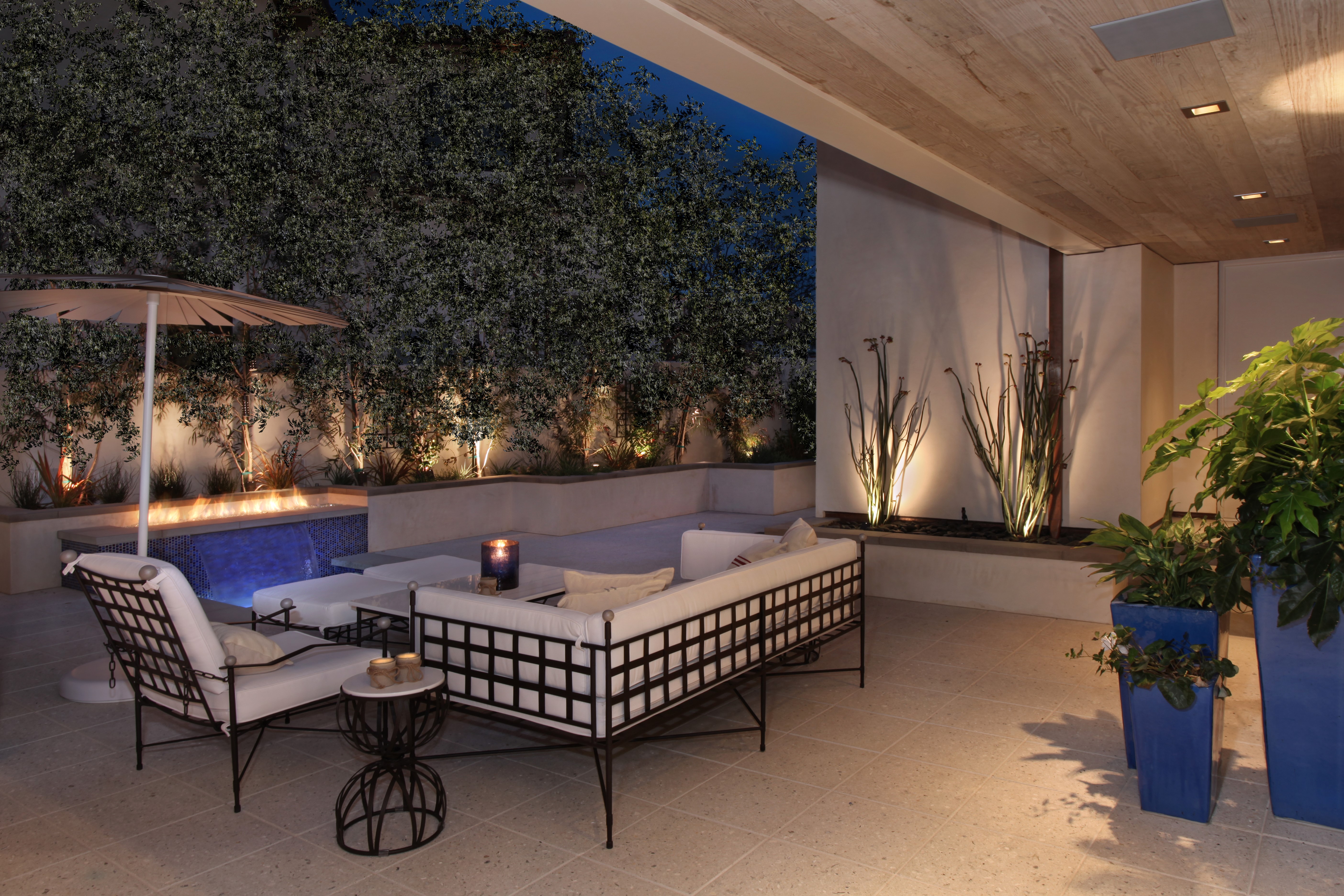 Outdoor Patio with Fireplace and Seating at Night HD Wallpaper