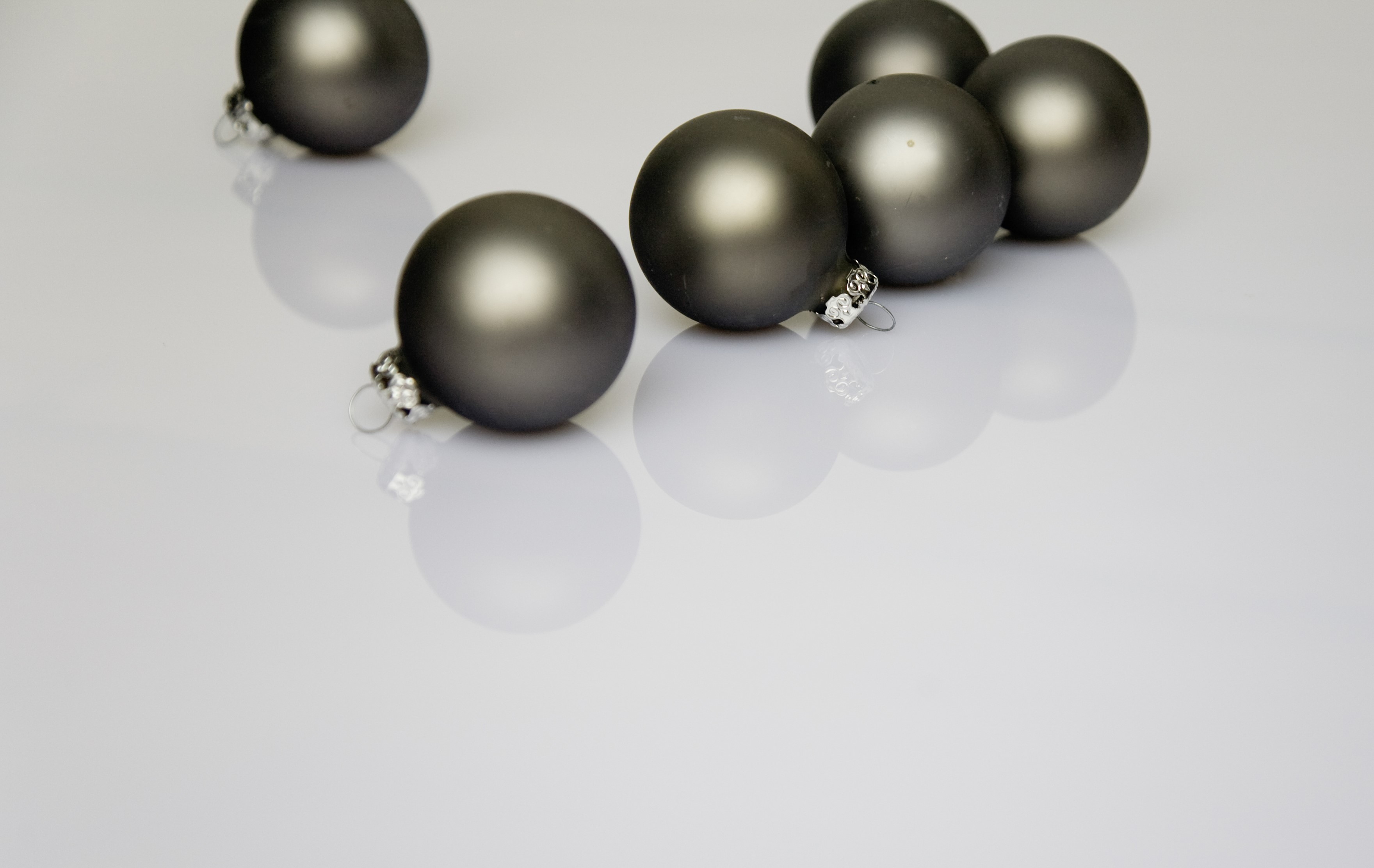 Gray Christmas Ornaments on Reflective Surface HD Wallpaper