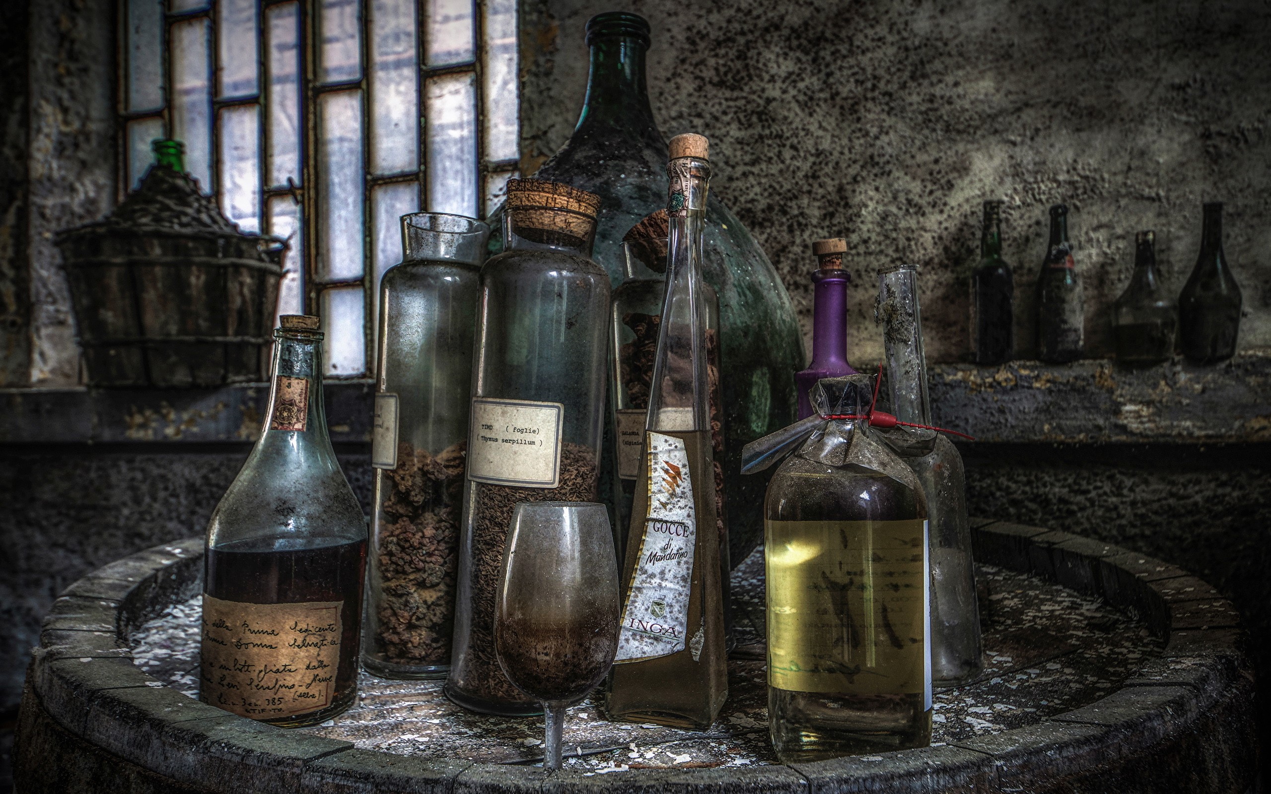 Old bottles and stemware on a barrel HD Wallpaper