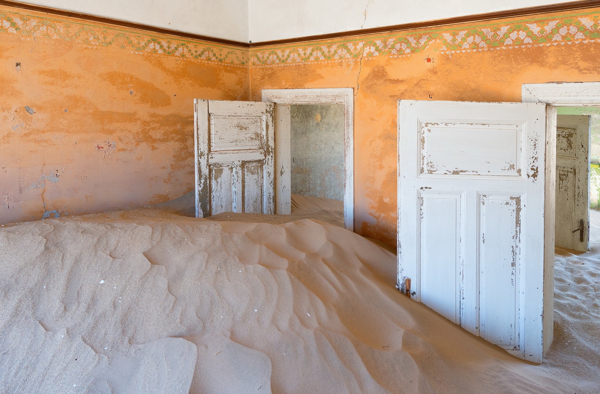 Abandoned room filled with sand and doors HD Wallpaper