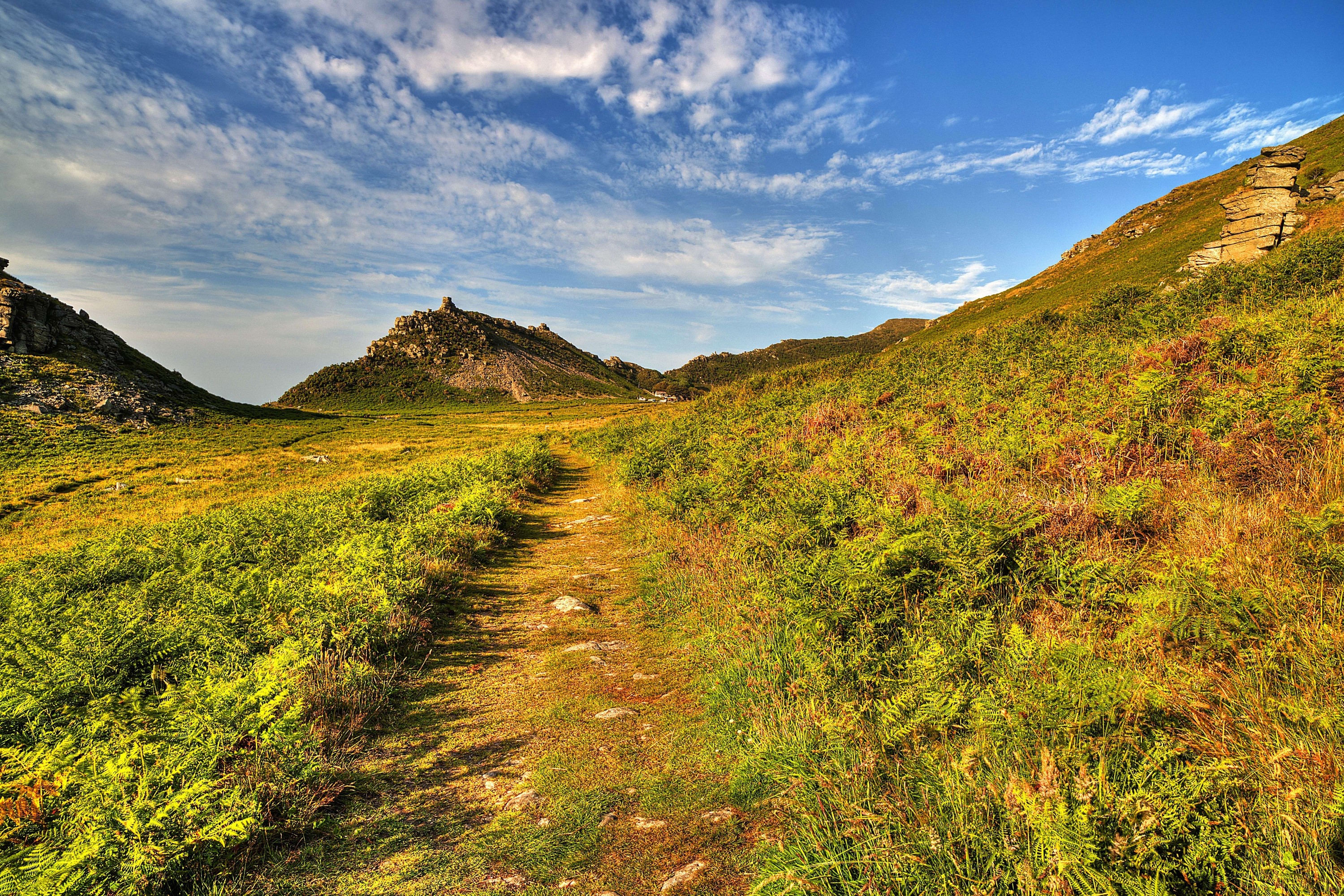Path through Exmoor National Park with mountains and sky HD Wallpaper