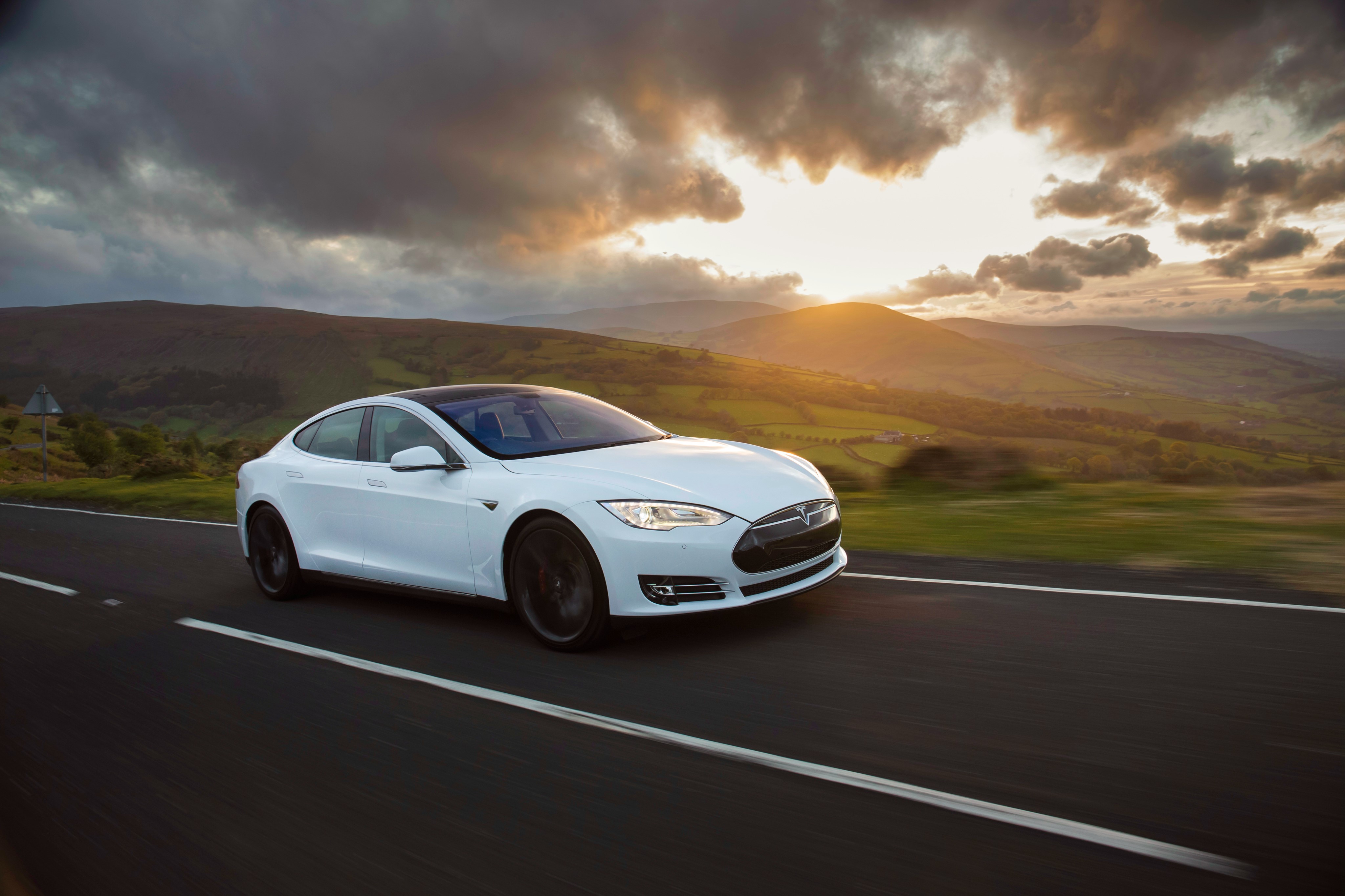 White Tesla Model S P85 driving on a road HD Wallpaper
