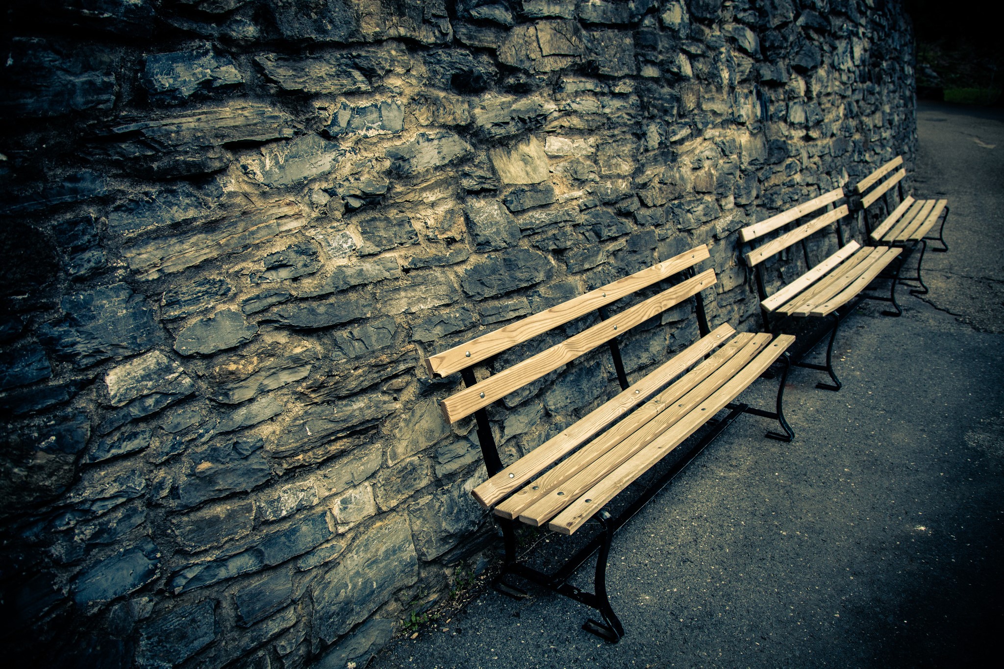 Stone wall with wooden benches HD Wallpaper