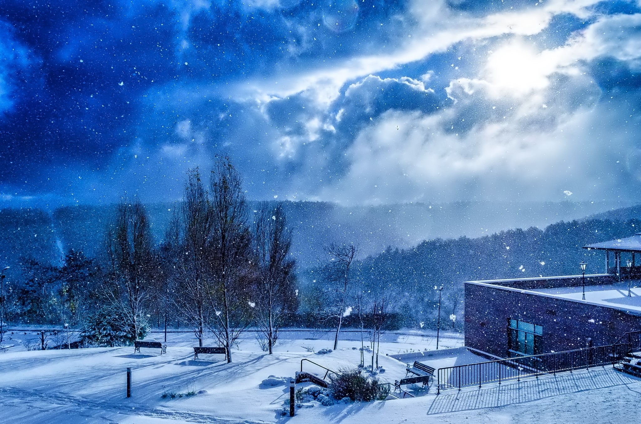 Winter scene with snow falling and a building HD Wallpaper