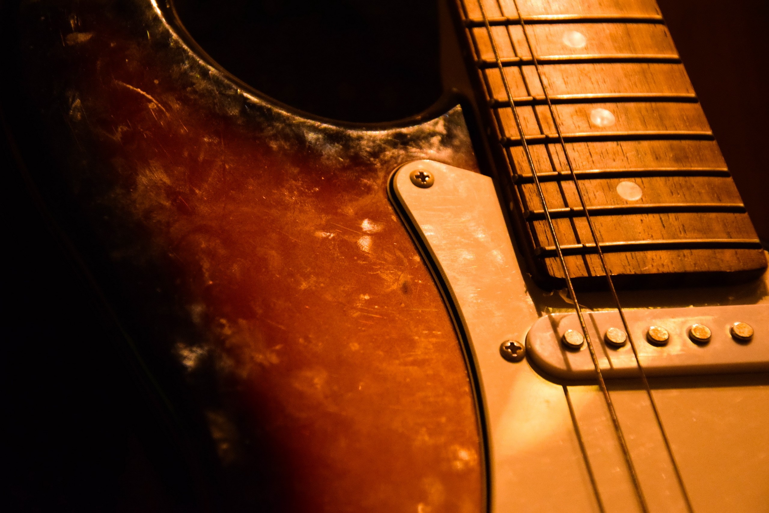 Closeup of a worn electric guitar HD Wallpaper