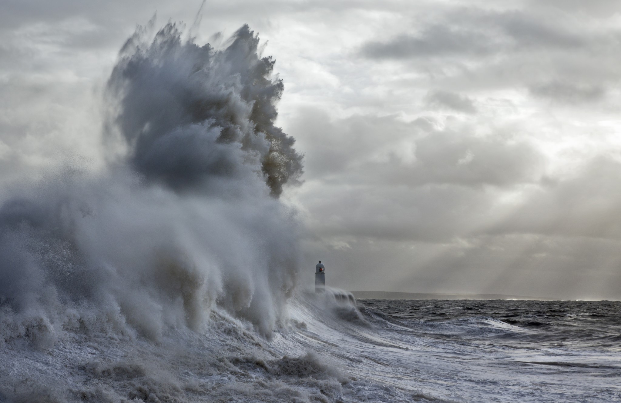 Massive wave crashing near a lighthouse HD Wallpaper