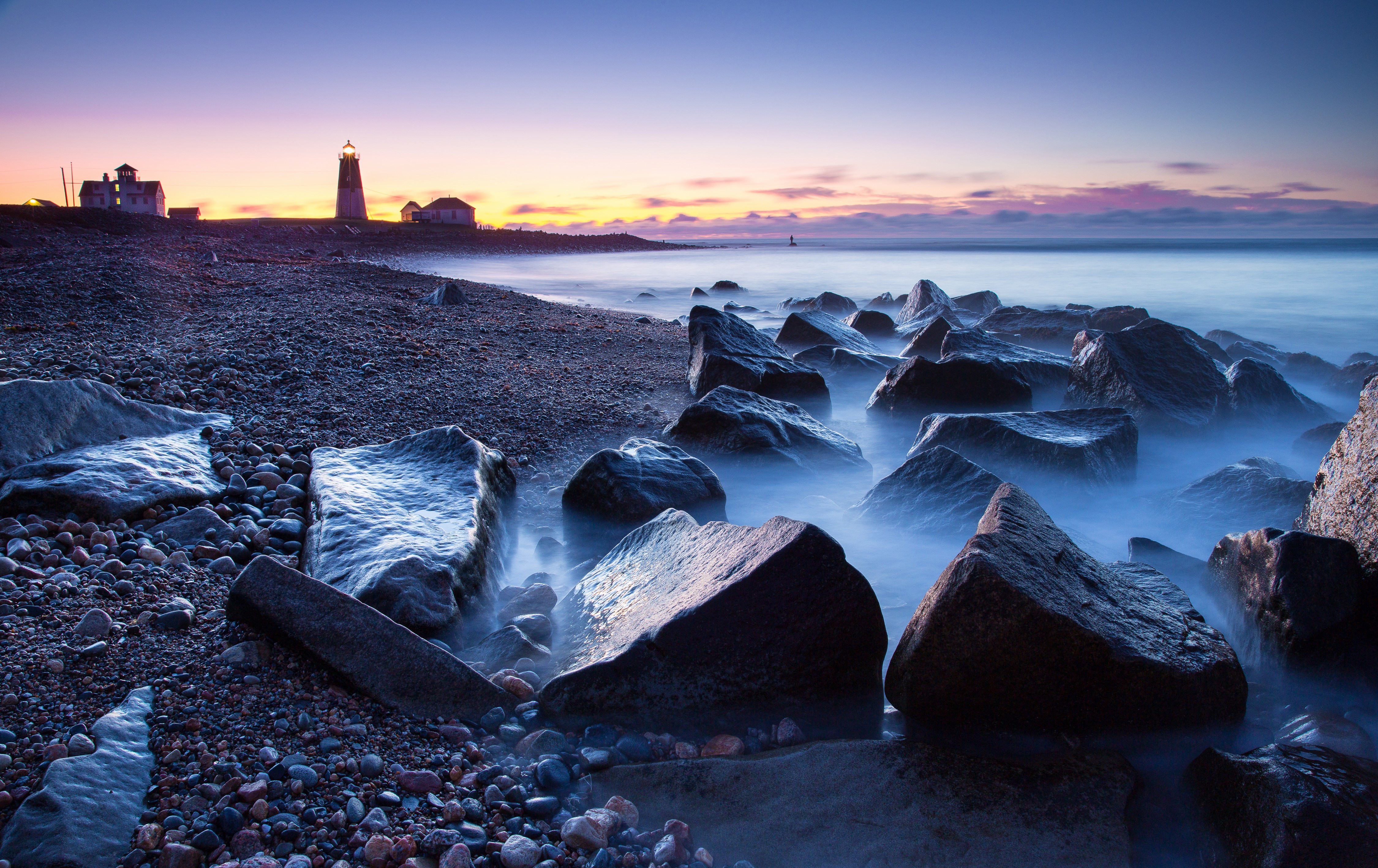 4K Lighthouse on Rocky Shore at Dusk HD Wallpaper
