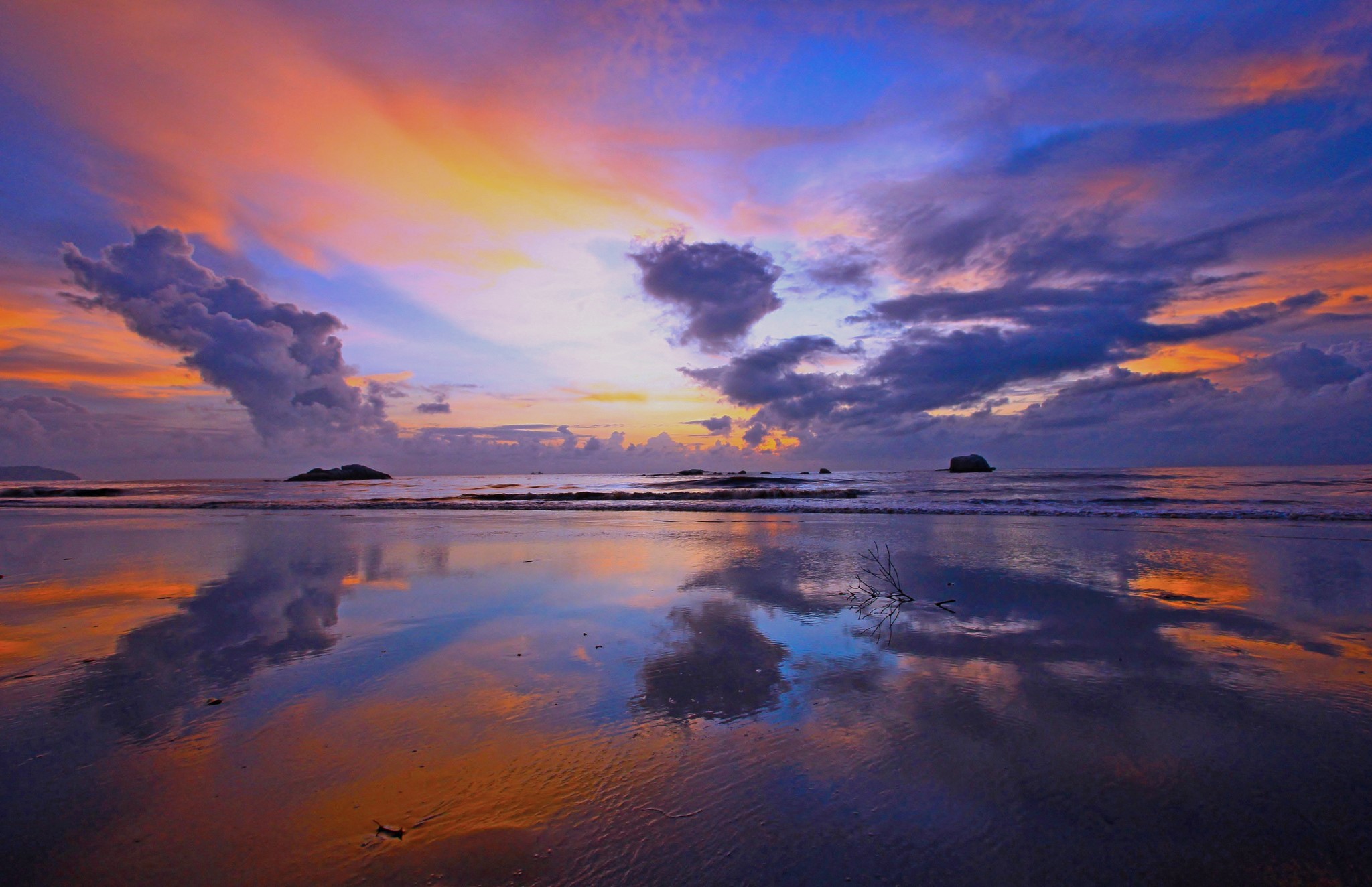 Sunset over the ocean with colorful clouds and reflections HD Wallpaper