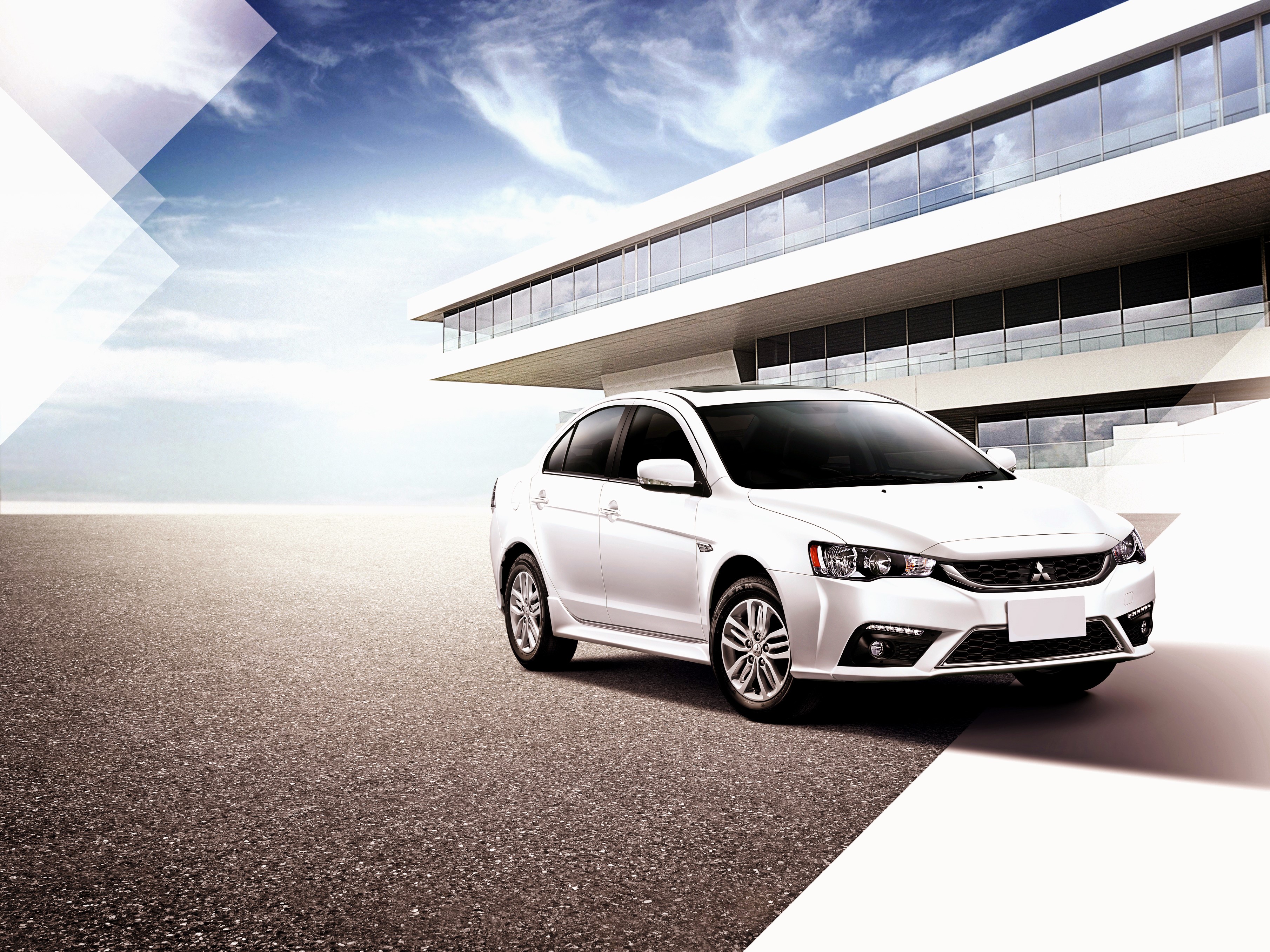 White Mitsubishi Lancer Fortis TW-spec parked in front of modern building HD Wallpaper