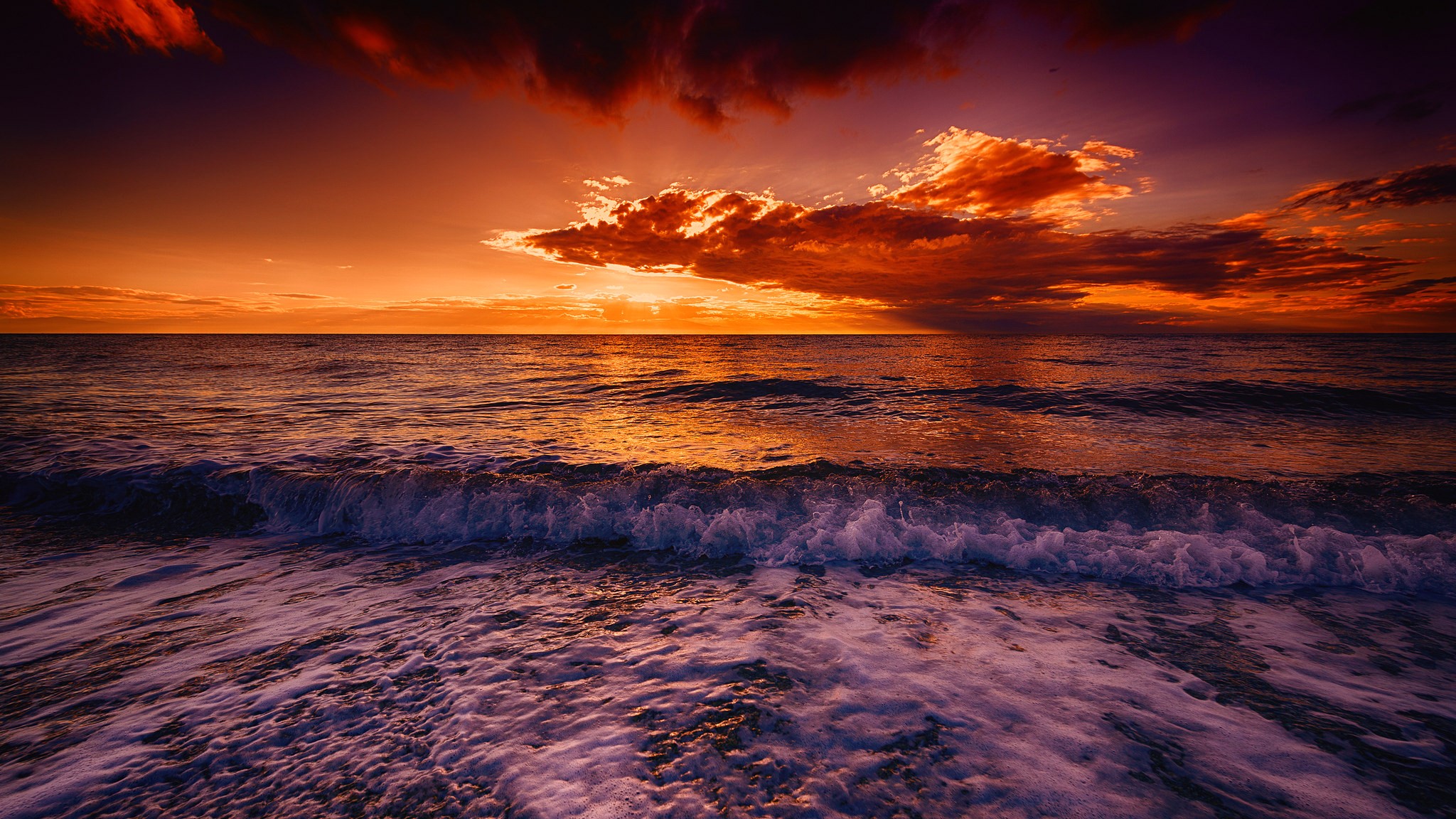 Ocean waves at sunset with dramatic clouds HD Wallpaper