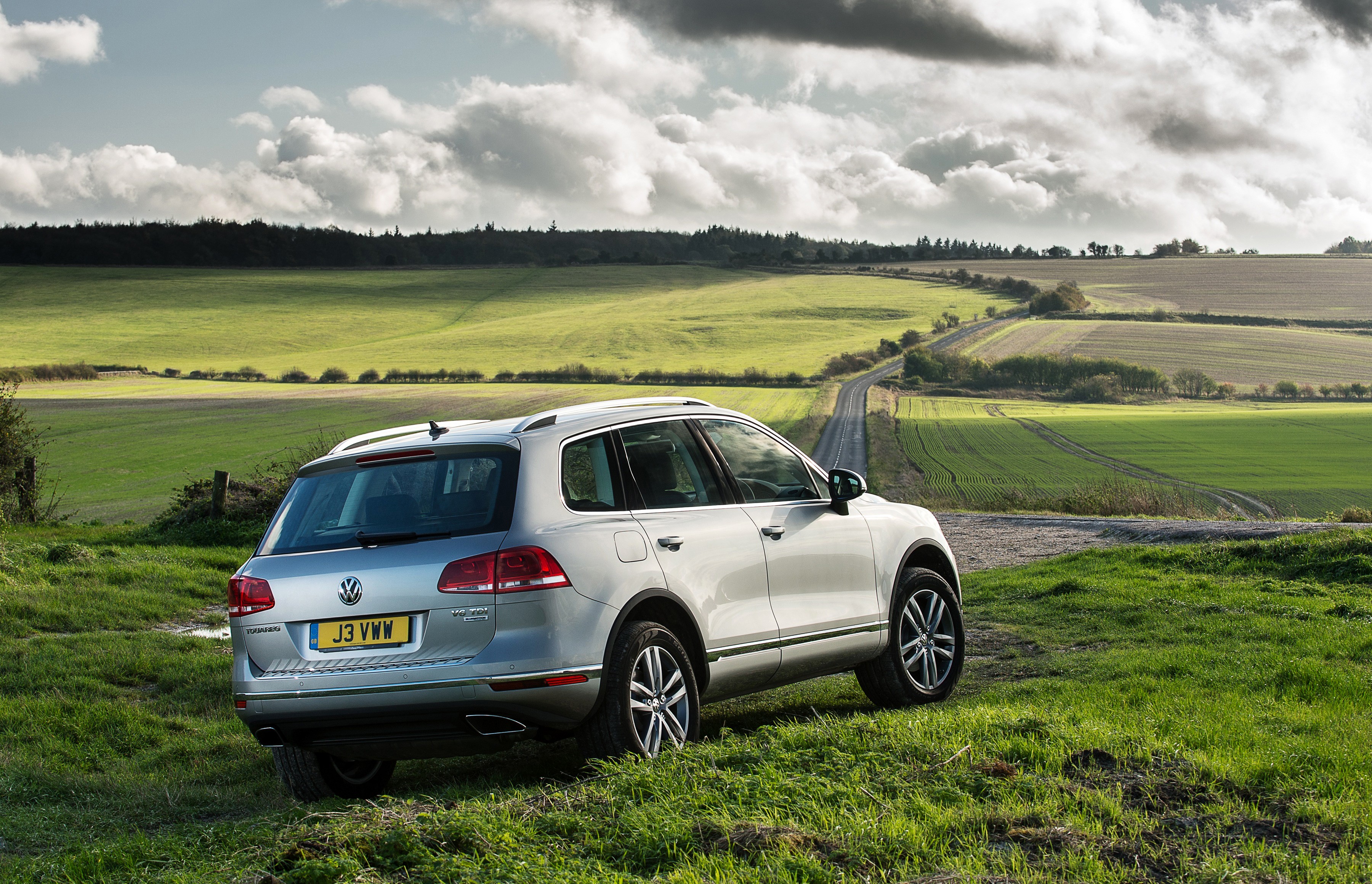 Silver Volkswagen Touareg in a rural landscape HD Wallpaper