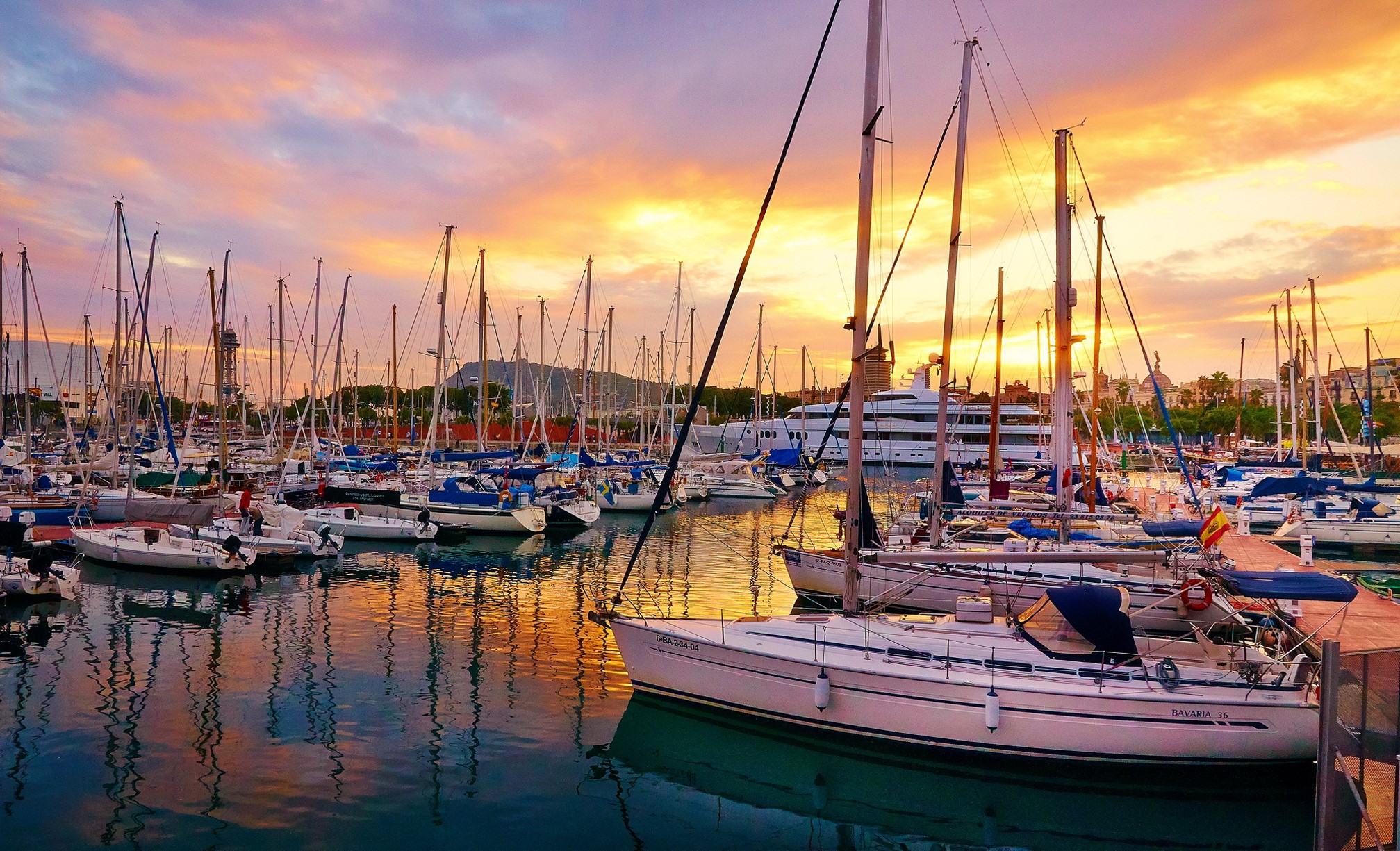 Sailboats docked in a marina at sunset HD Wallpaper
