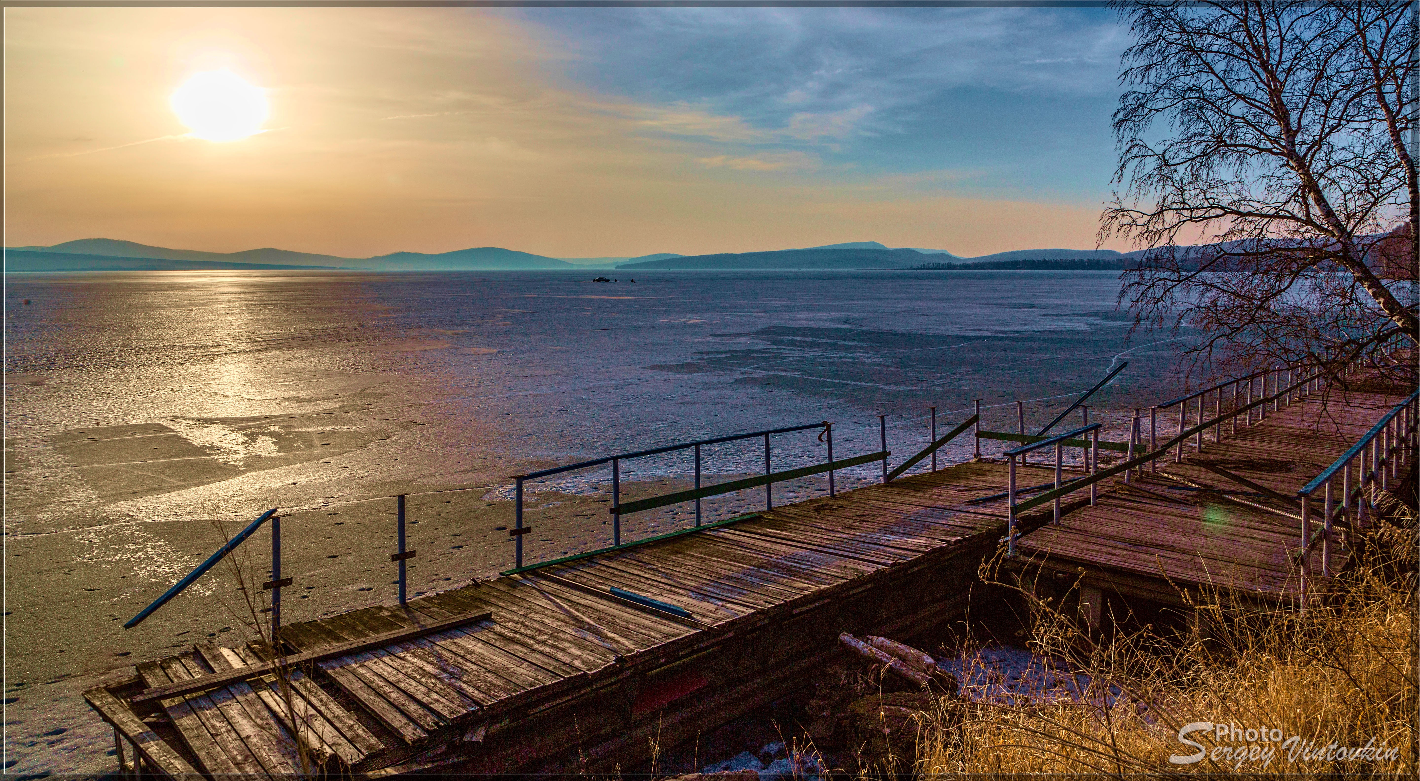 Wooden bridges over frozen lake at sunset HD Wallpaper