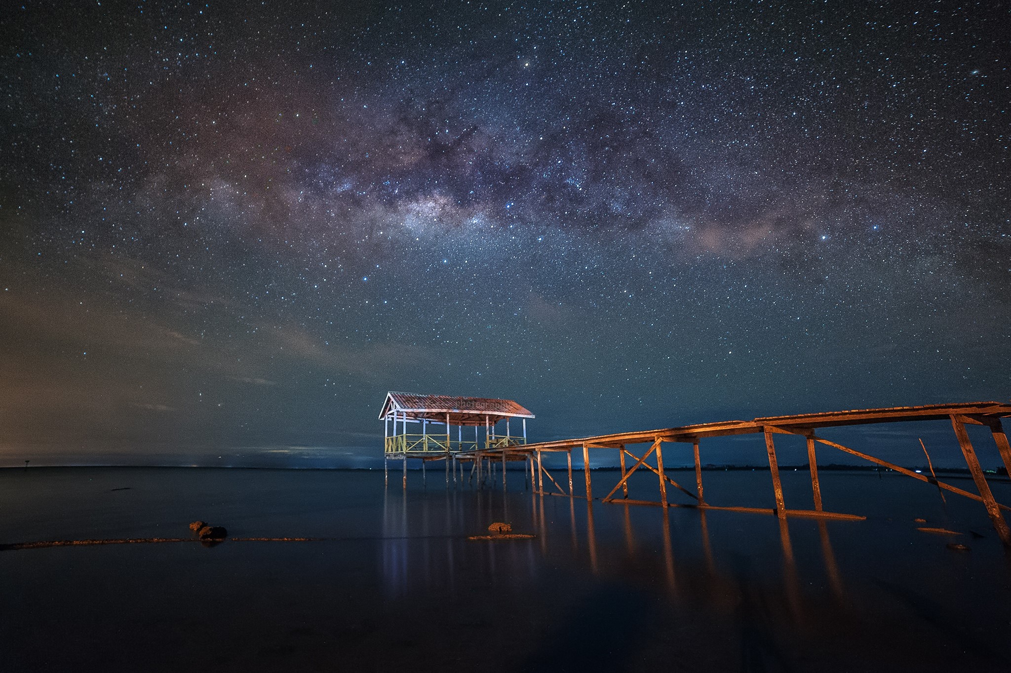 Milky Way over a wooden pier and hut on the water HD Wallpaper