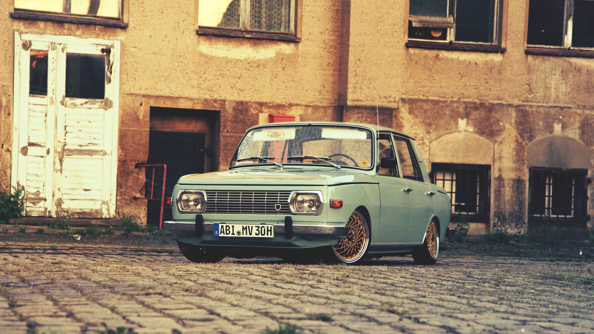 Vintage Wartburg car parked on cobblestone street HD Wallpaper