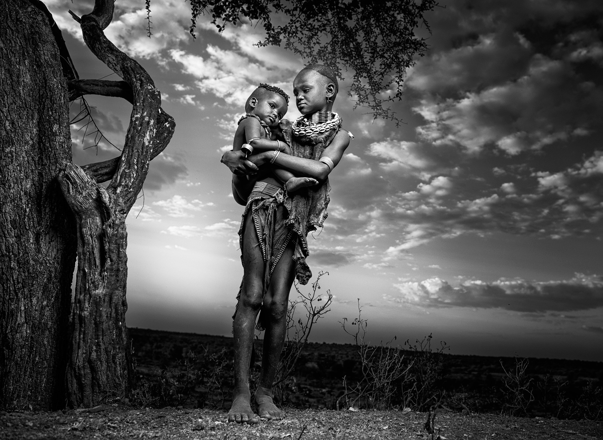 Young girl holding a baby in Ethiopia HD Wallpaper