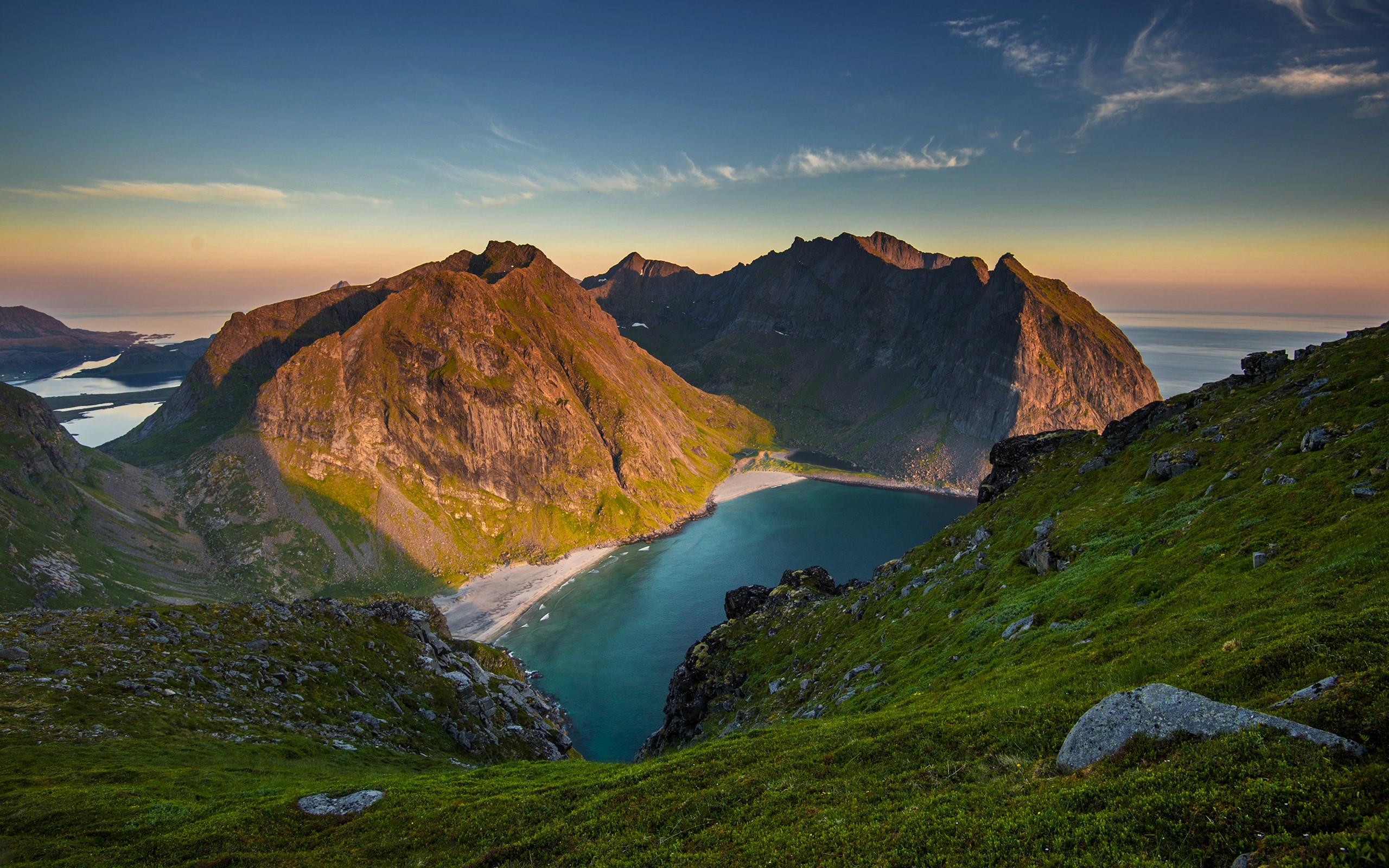 Mountains overlooking a cove and the ocean at sunset HD Wallpaper