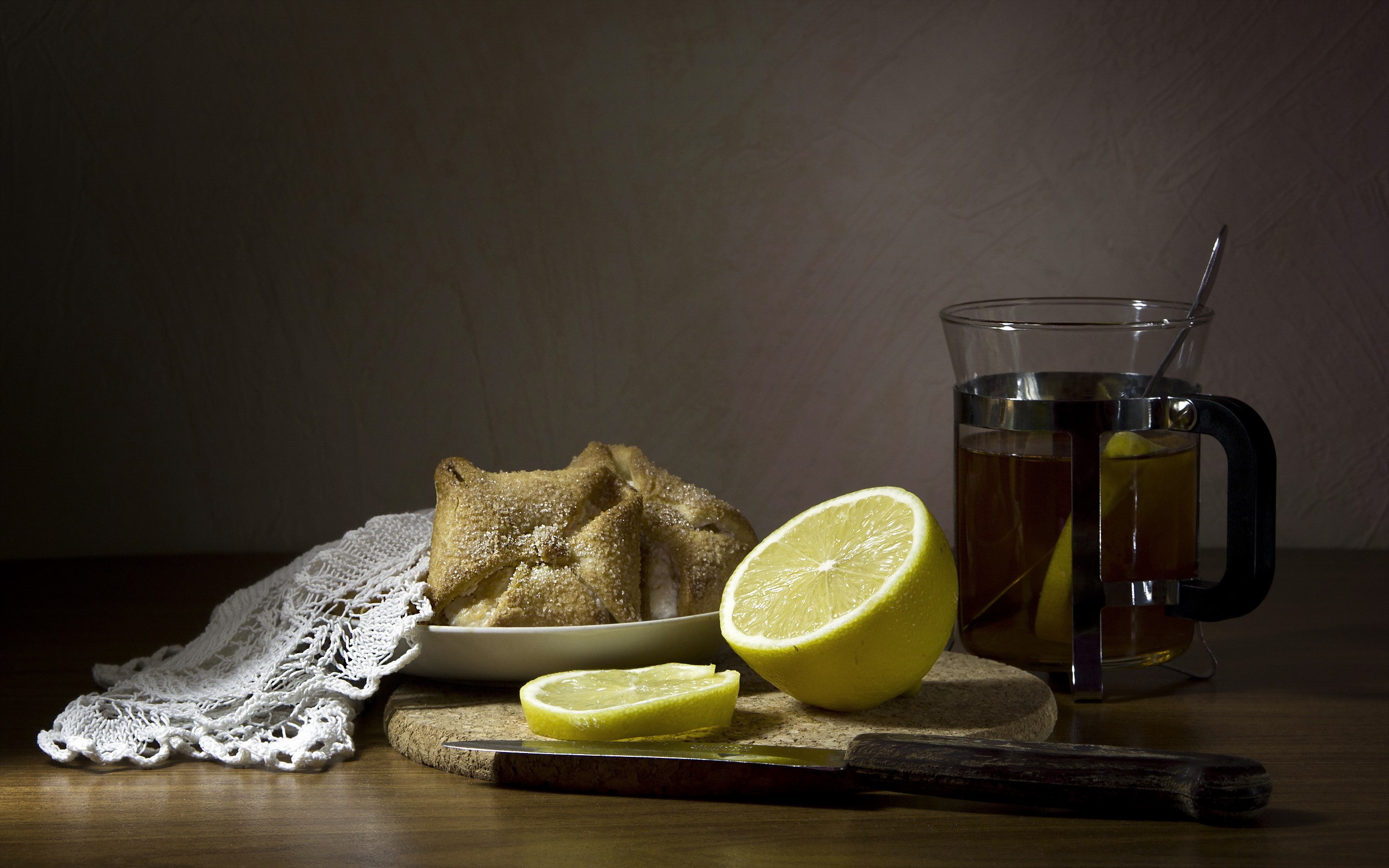 Tea with lemon and pastries on a table HD Wallpaper