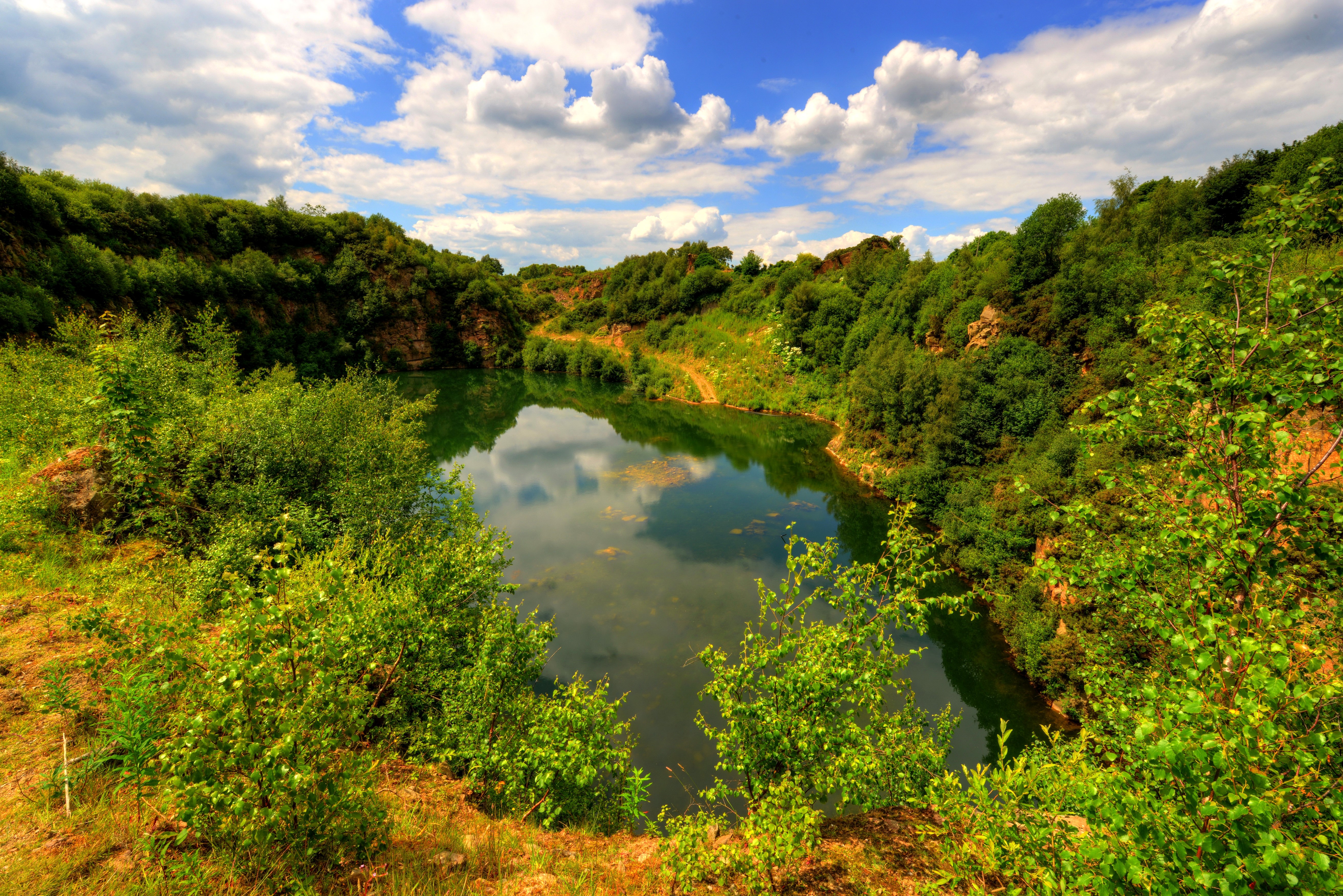 Lake surrounded by trees and shrubs in Lancashire, England HD Wallpaper