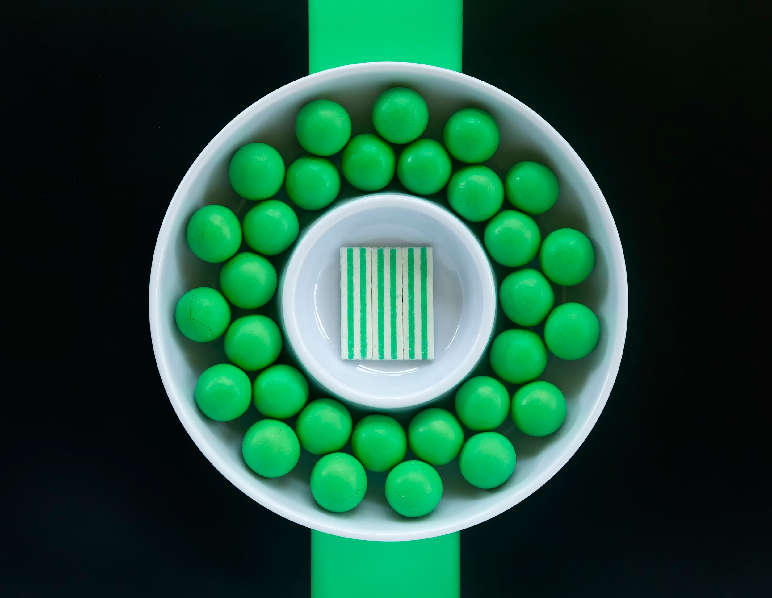 Green candies in a white bowl with striped candy HD Wallpaper