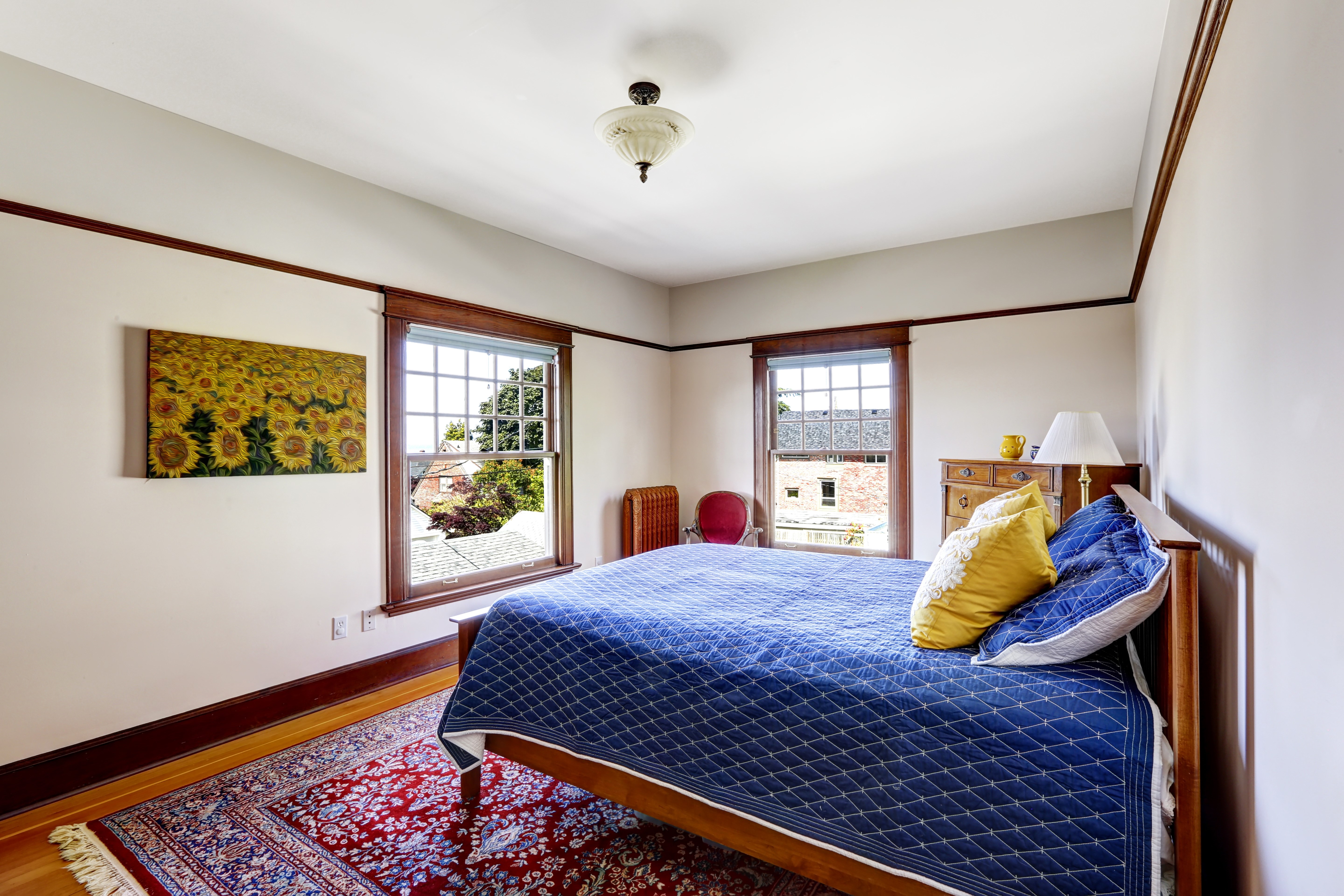 Bedroom with blue bed and sunflower painting HD Wallpaper