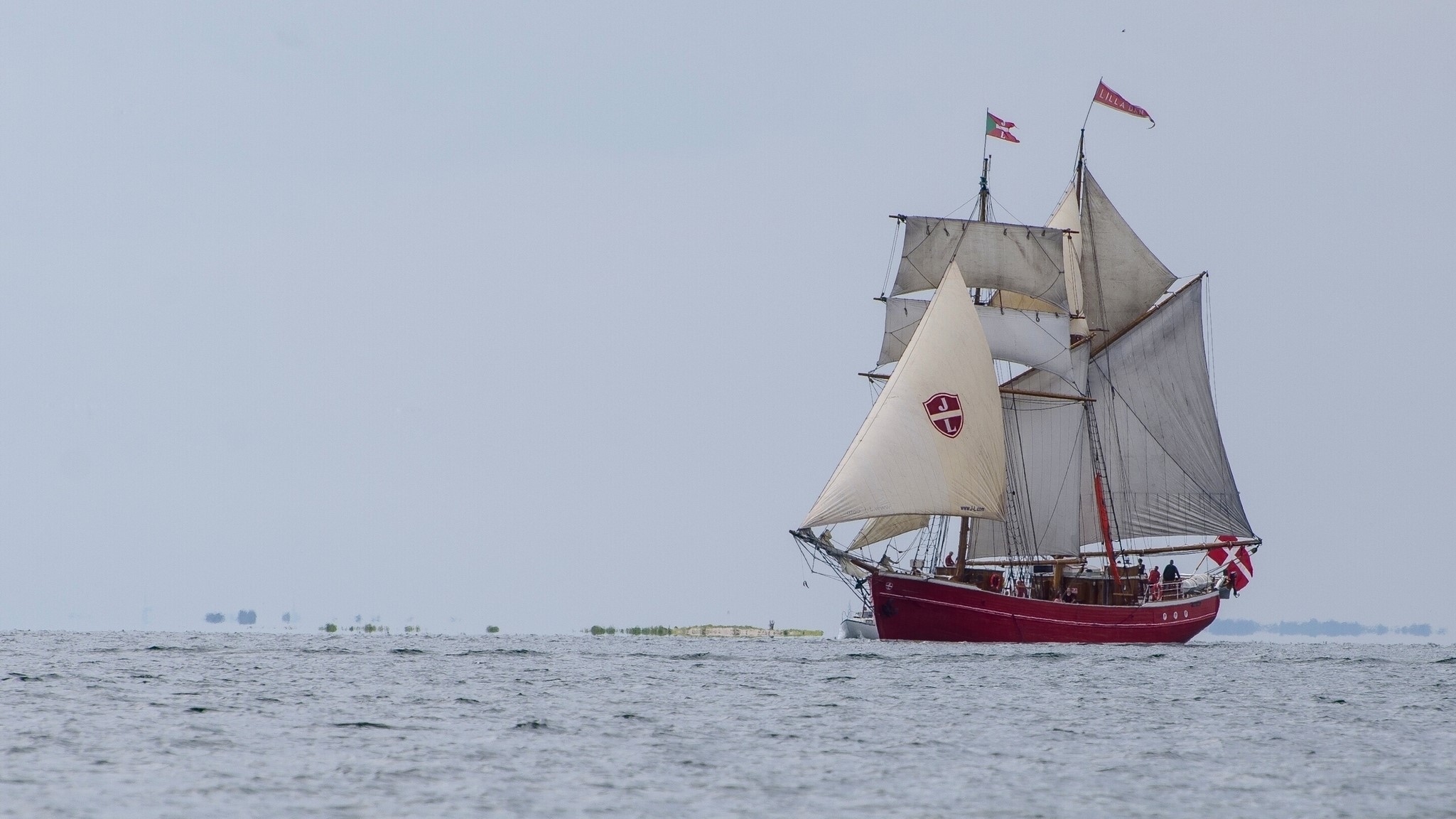 Red sailing ship with white sails on the sea HD Wallpaper