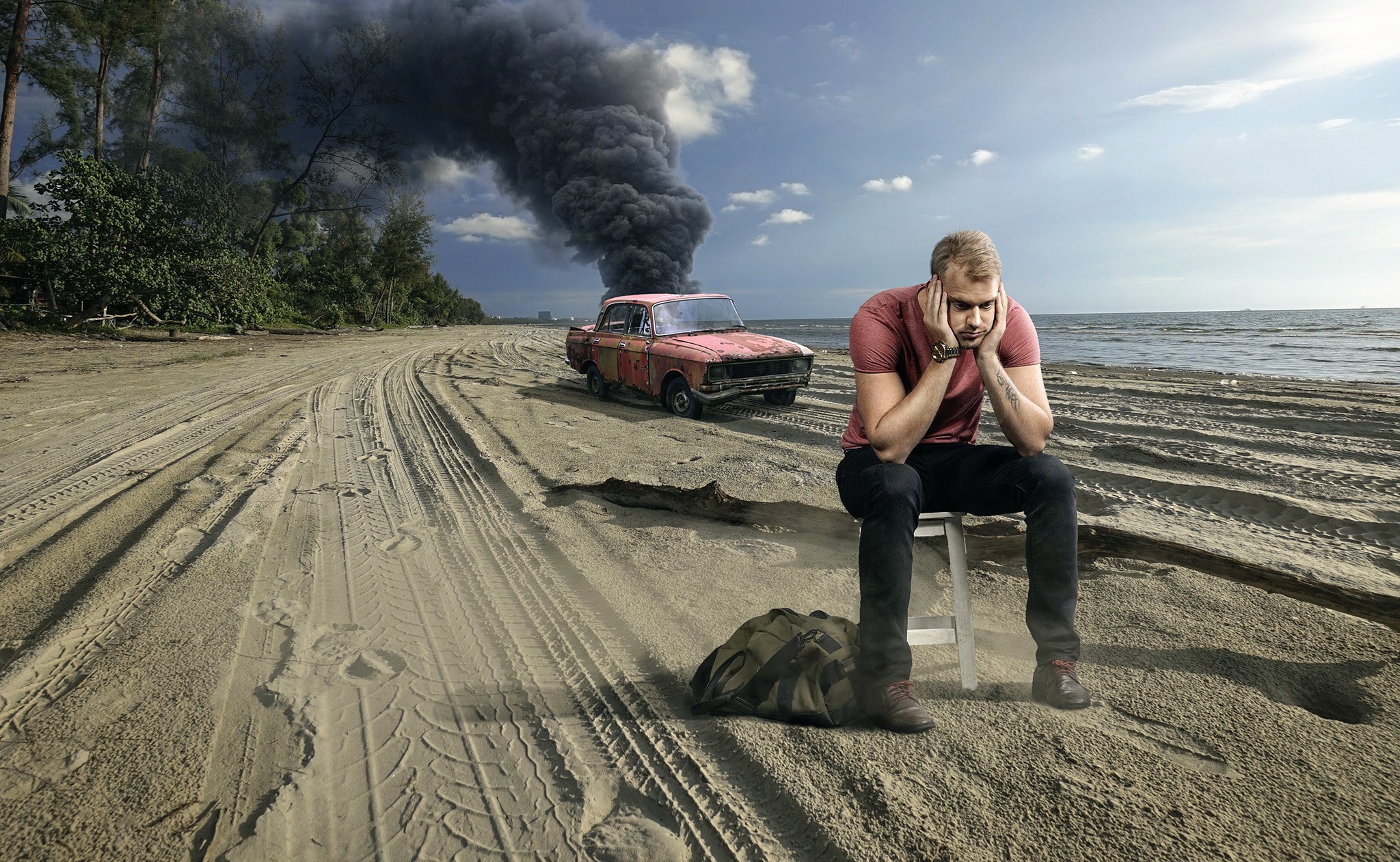 Man sitting on beach next to smoking car HD Wallpaper