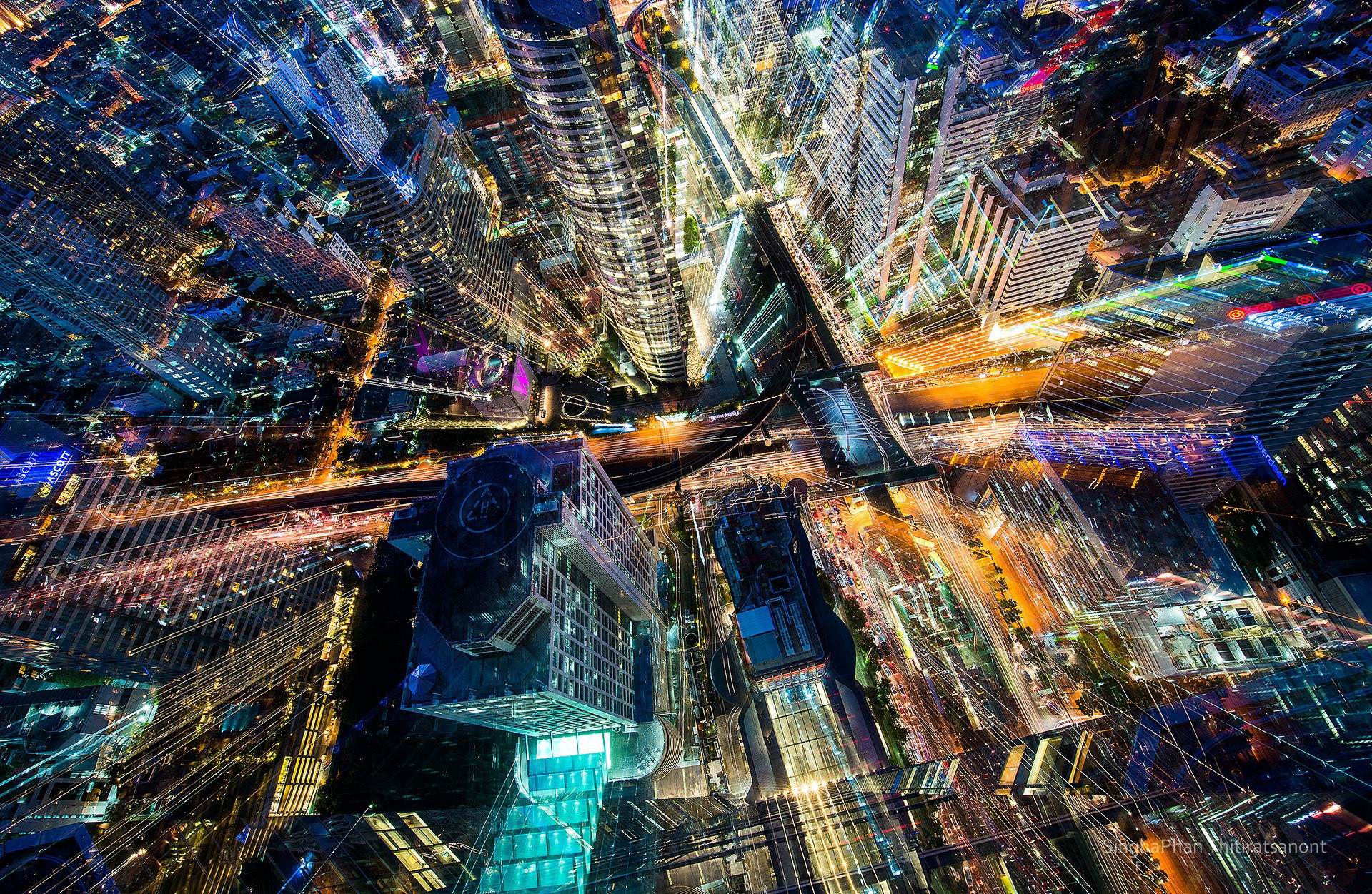 Aerial view of a city at night with light trails HD Wallpaper