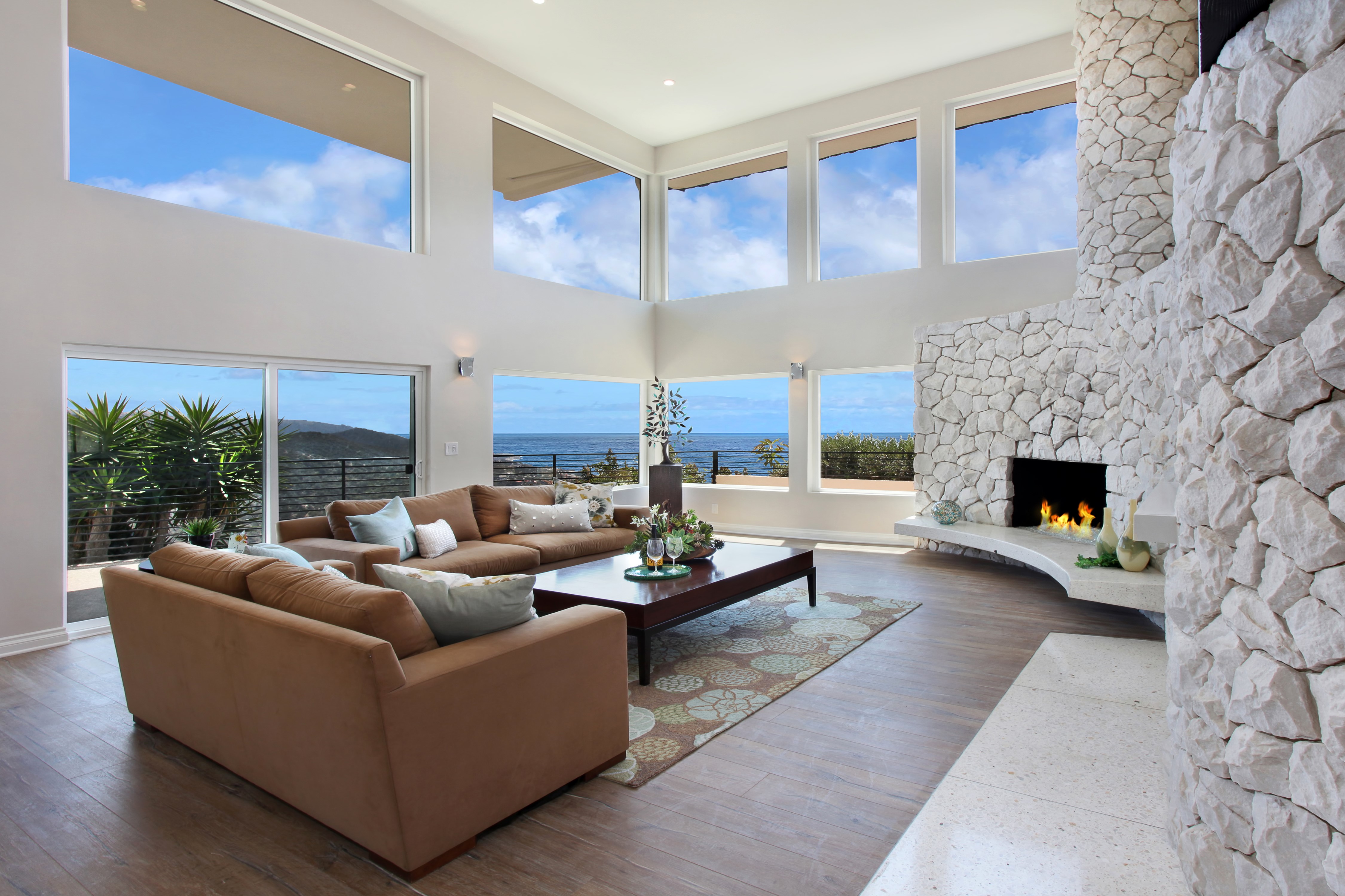 Living room with fireplace and ocean view HD Wallpaper