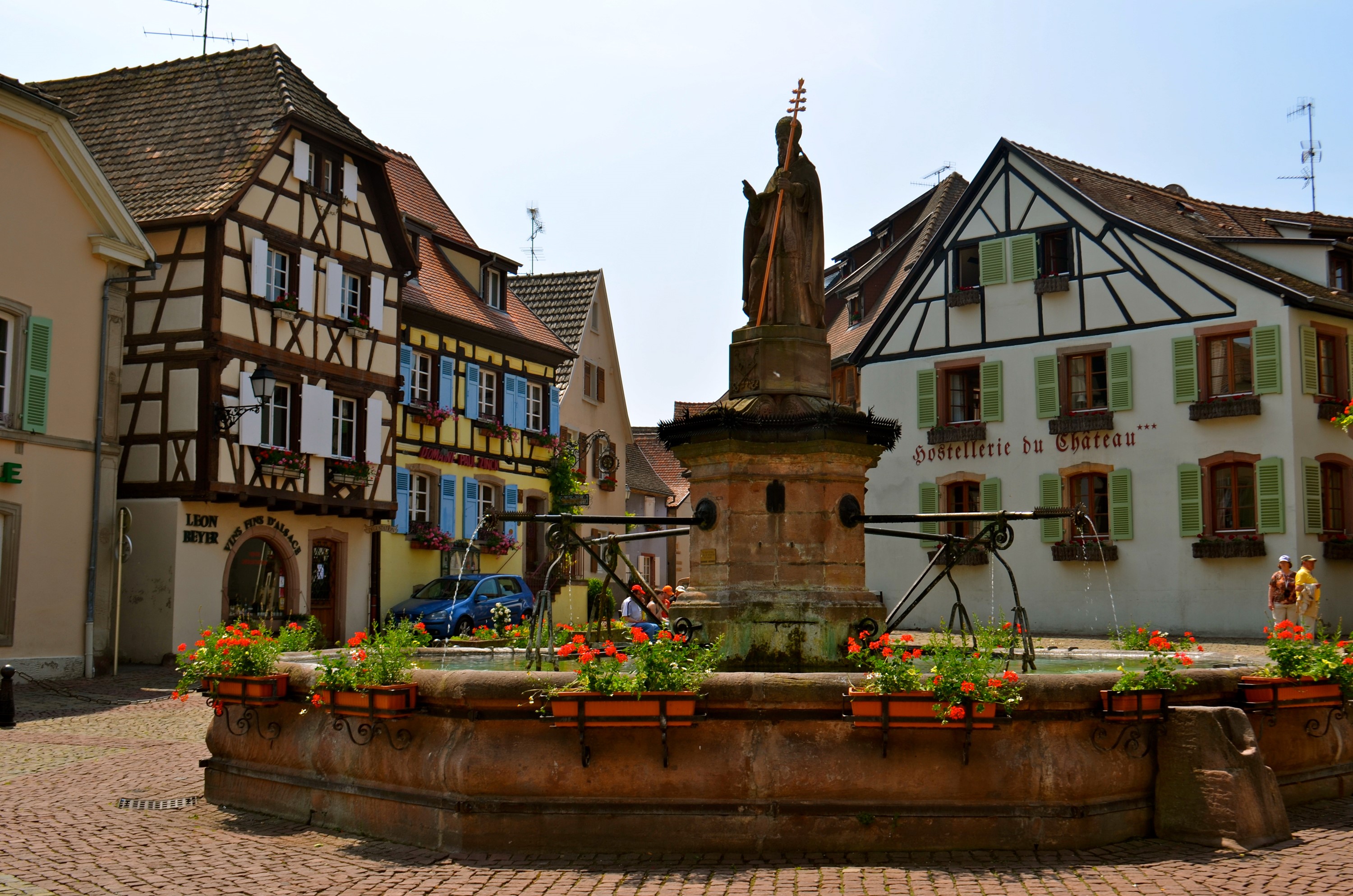 Fountain in Eguisheim, France with half-timbered houses HD Wallpaper