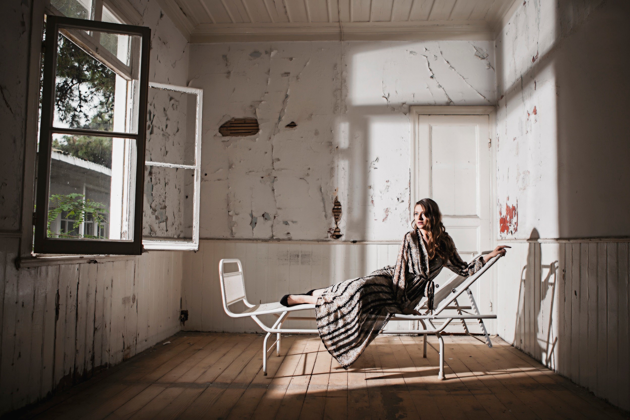 Woman on a sunlounger in an abandoned room HD Wallpaper