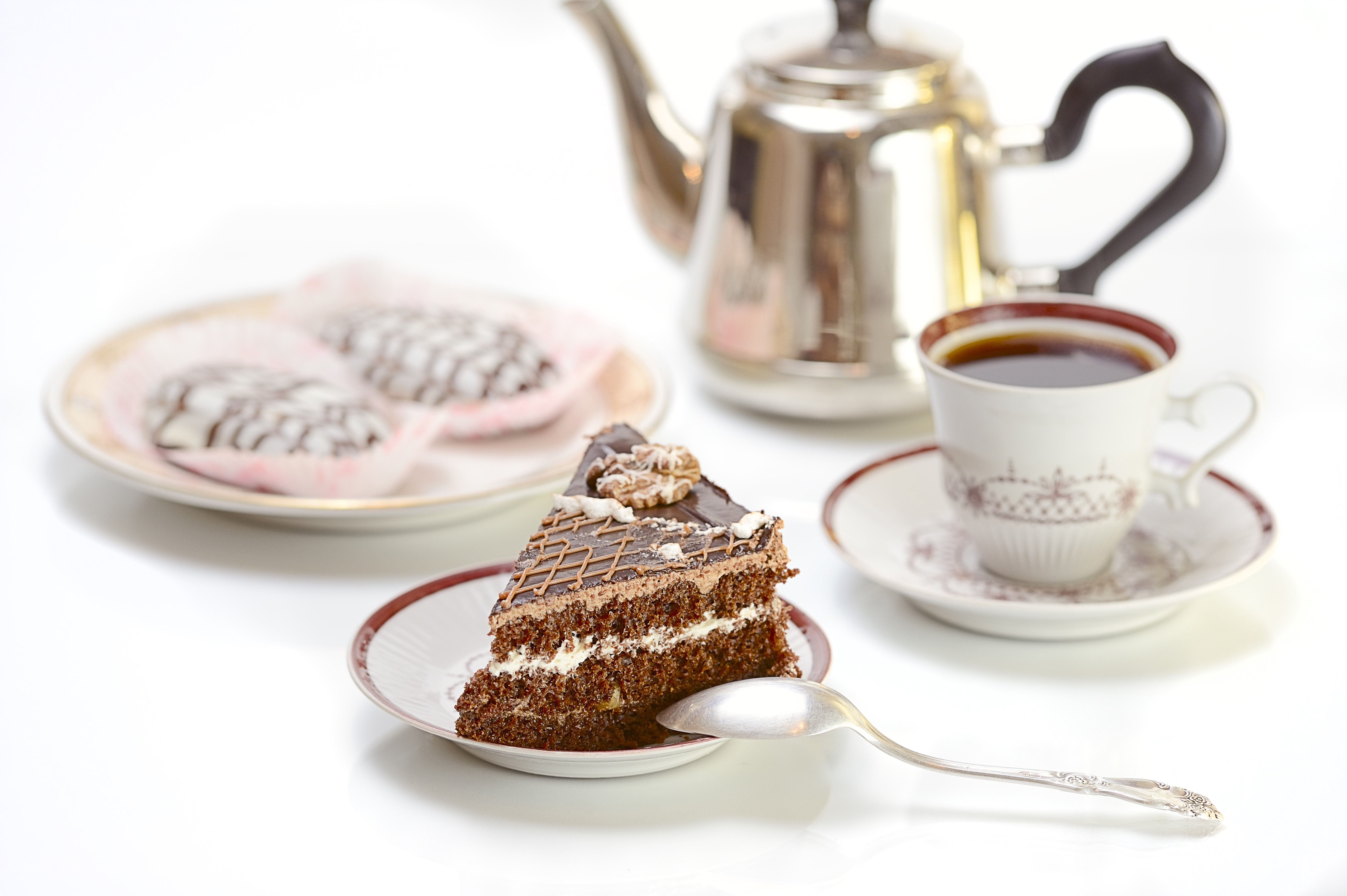 Slice of chocolate cake with tea and pastries HD Wallpaper