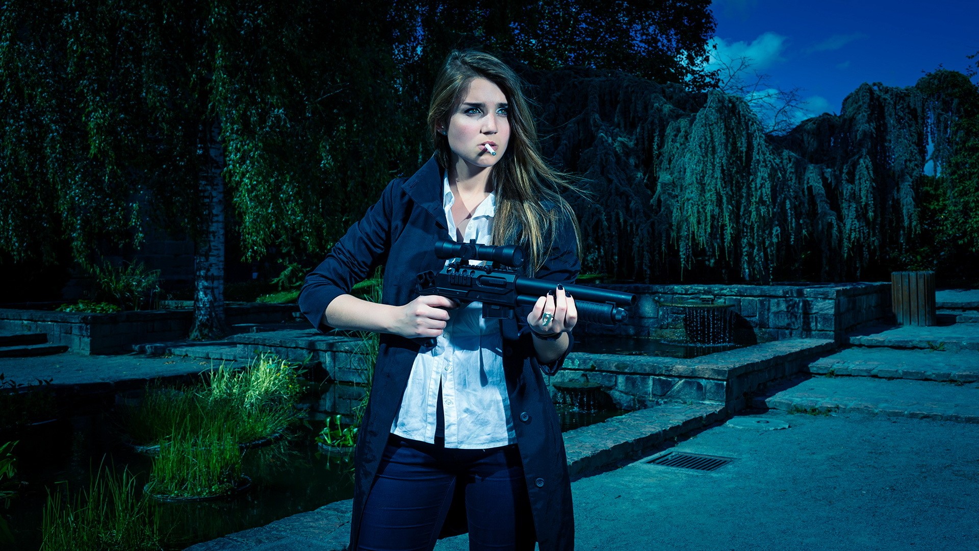 Woman holding a rifle in a park HD Wallpaper