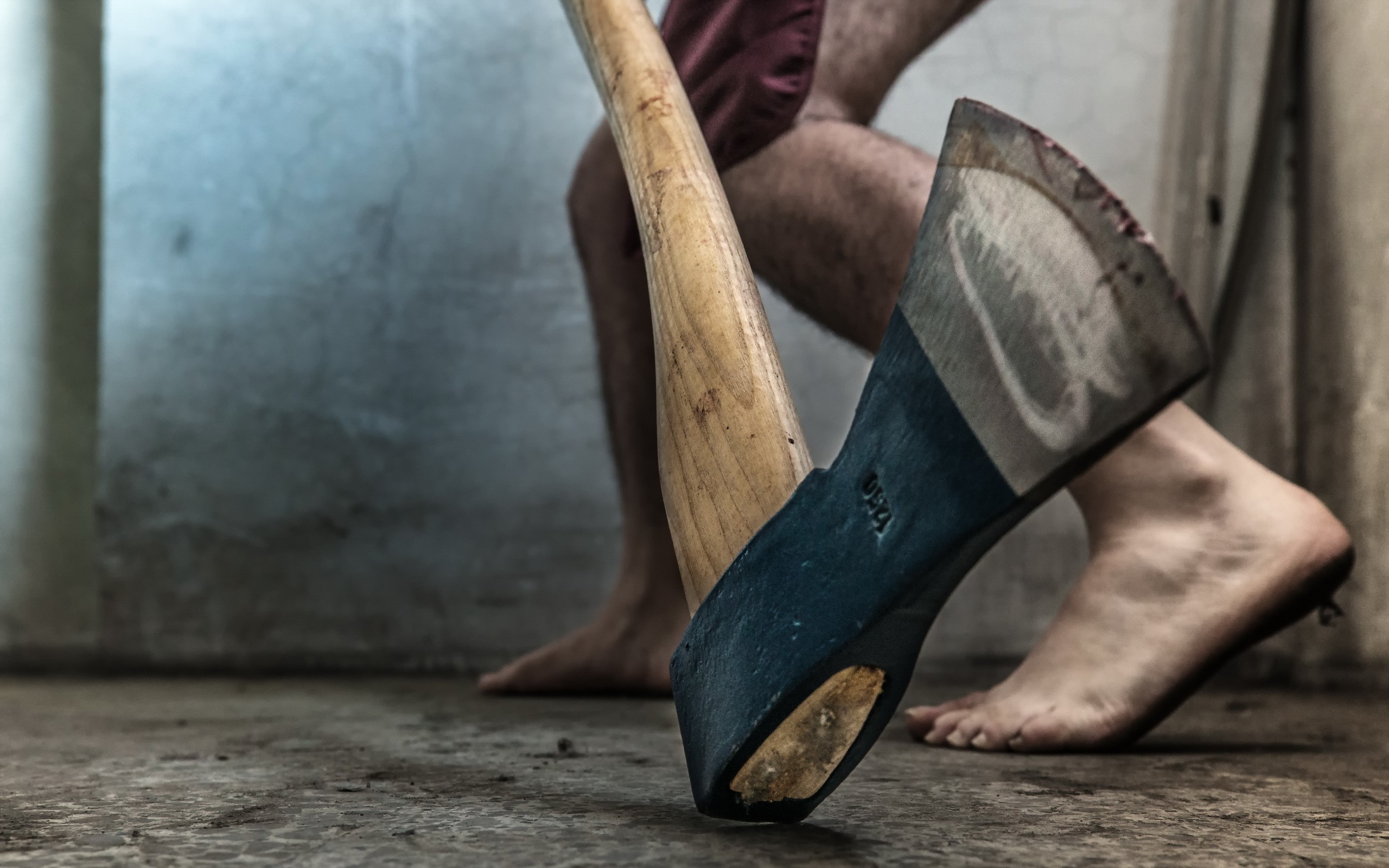 Man with axe standing on concrete floor HD Wallpaper