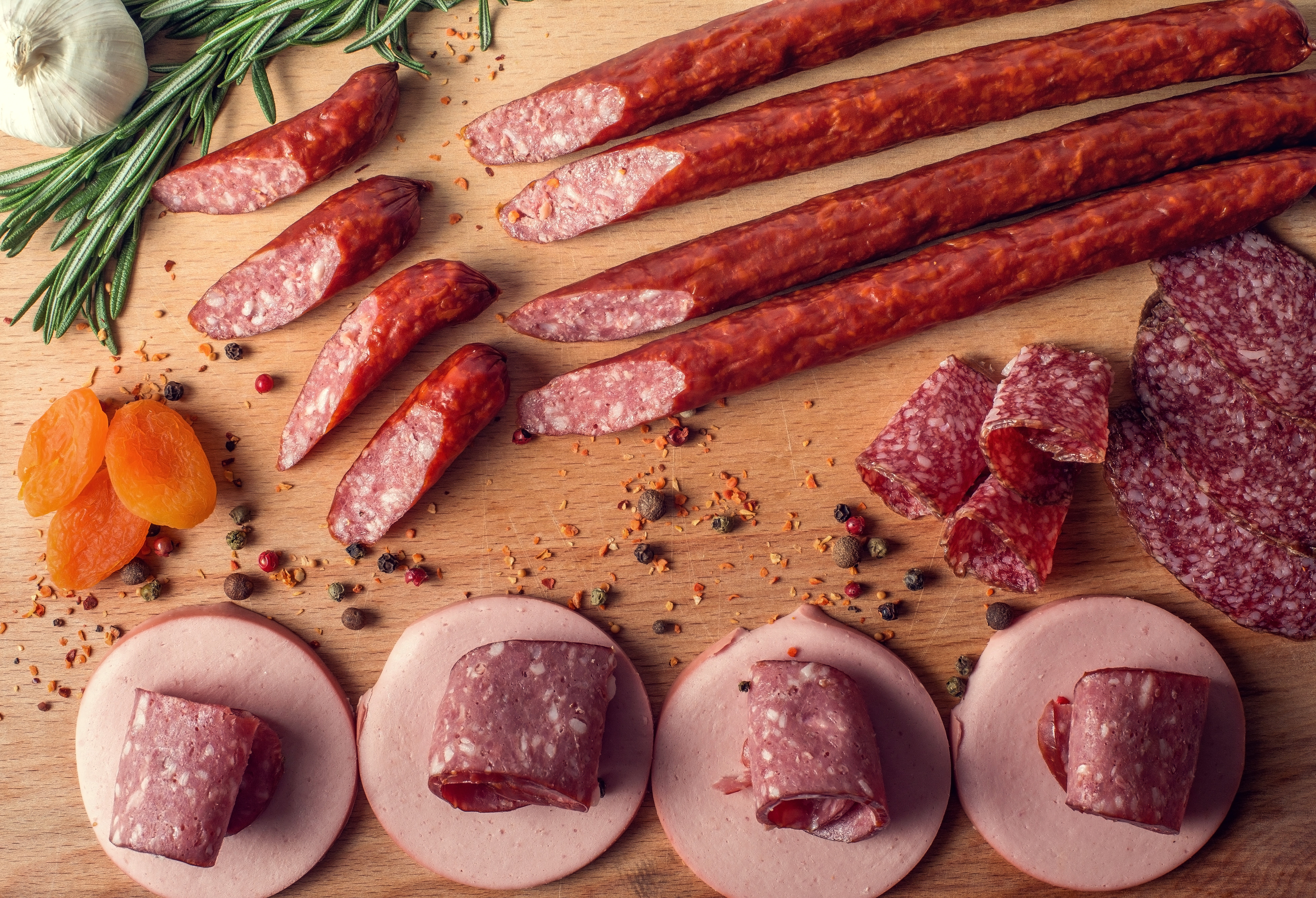 Sausages, Spices, Garlic, and Dried Apricots on a Wooden Board HD Wallpaper