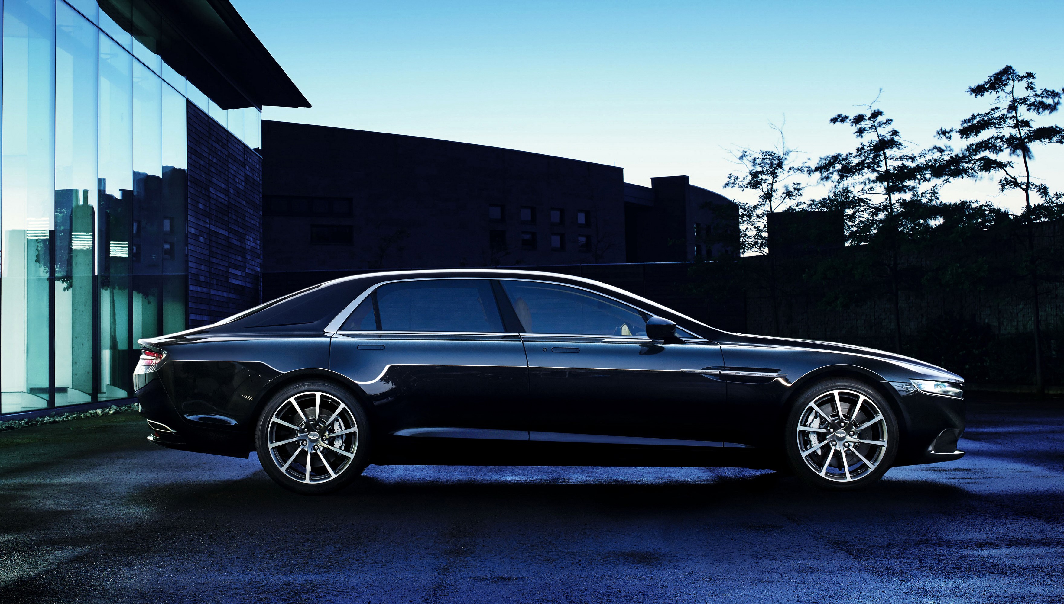 Black Aston Martin Lagonda parked outside modern building HD Wallpaper