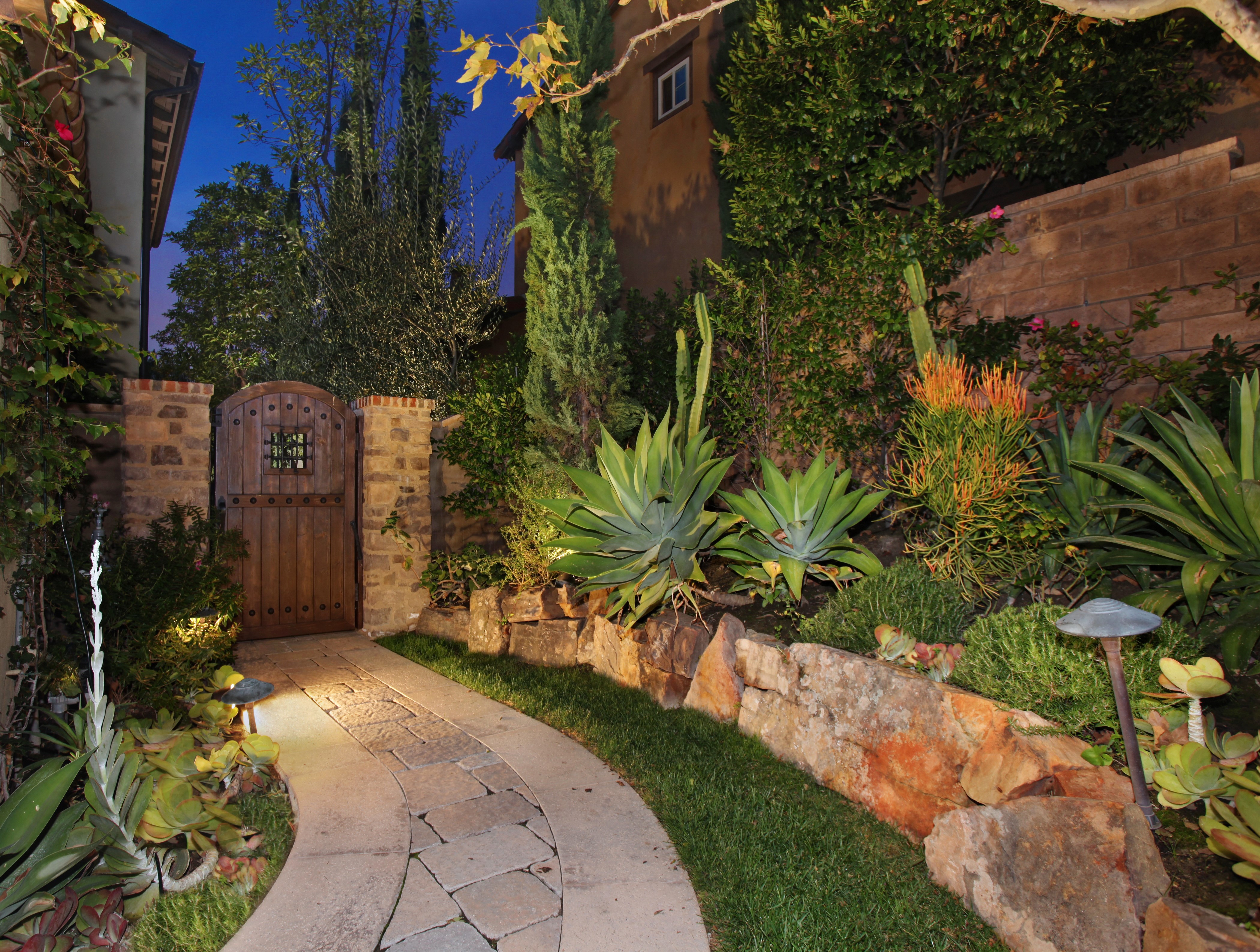 Garden pathway with wooden gate at night HD Wallpaper