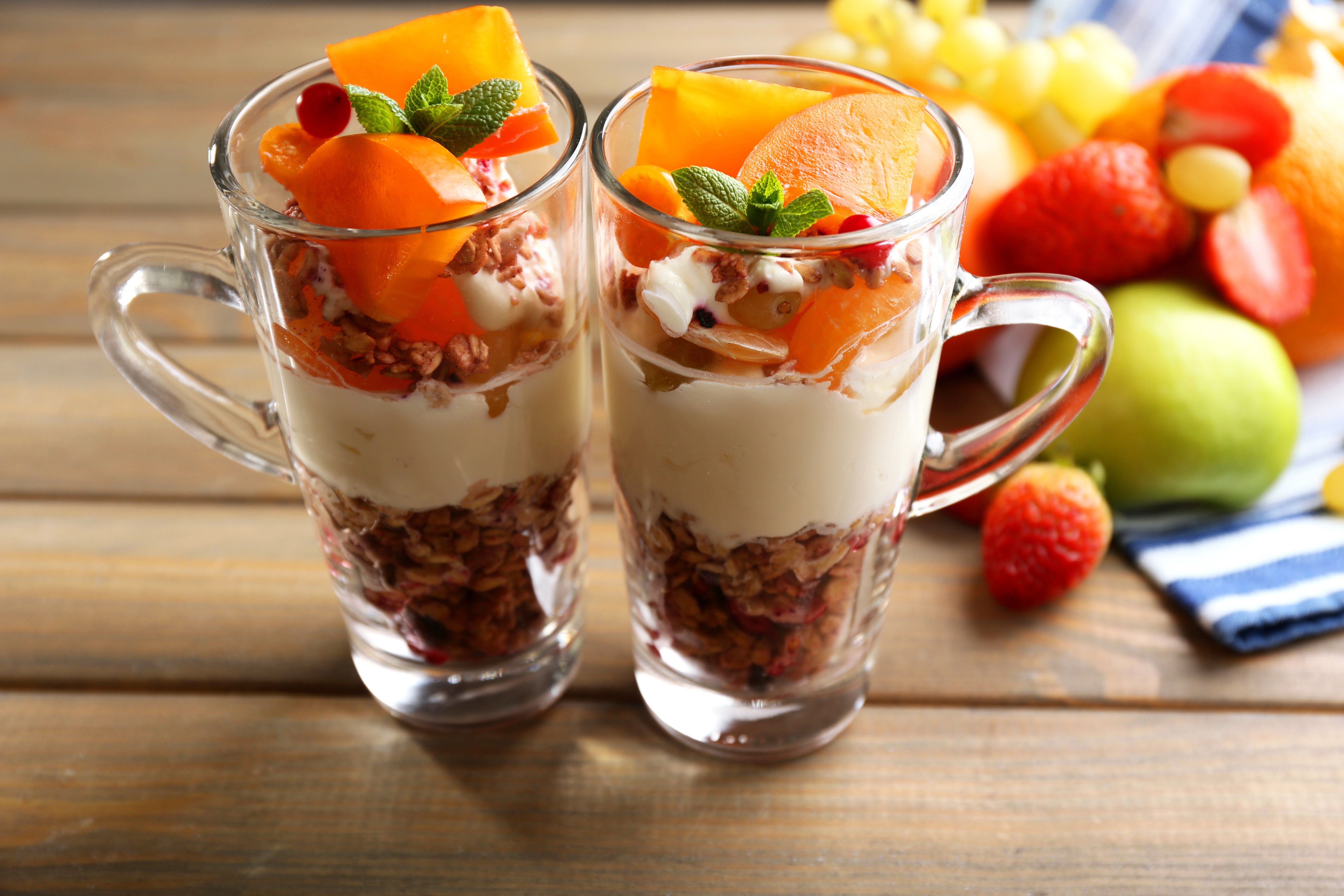 Two fruit parfaits in glasses with fruit on the side HD Wallpaper