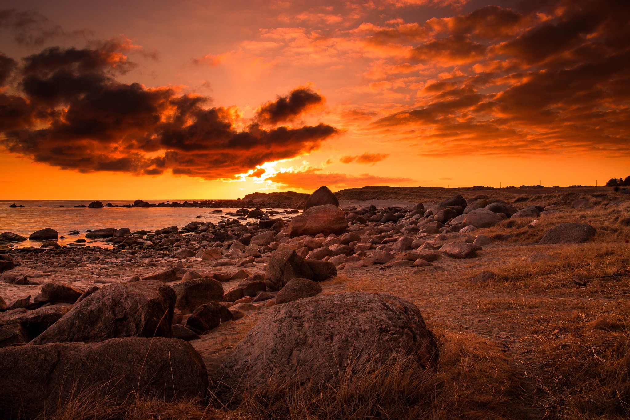 Rocky Coastline at Sunset with Dramatic Clouds HD Wallpaper