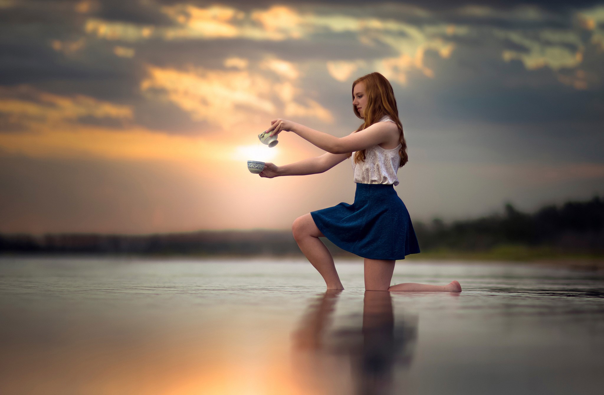 Girl pouring water from cup into bowl at sunset HD Wallpaper