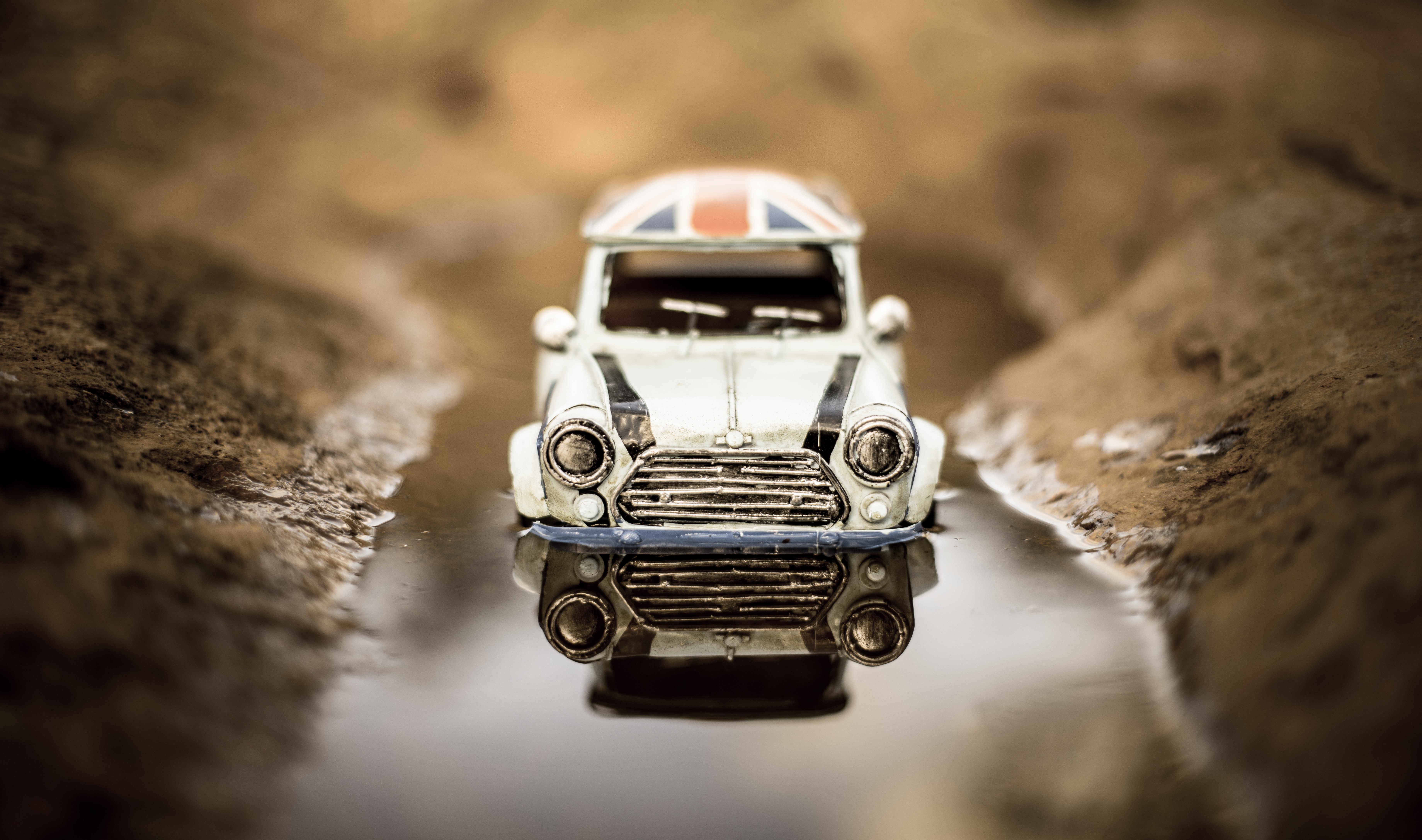 Toy Mini Car with Union Jack Roof in Puddle HD Wallpaper