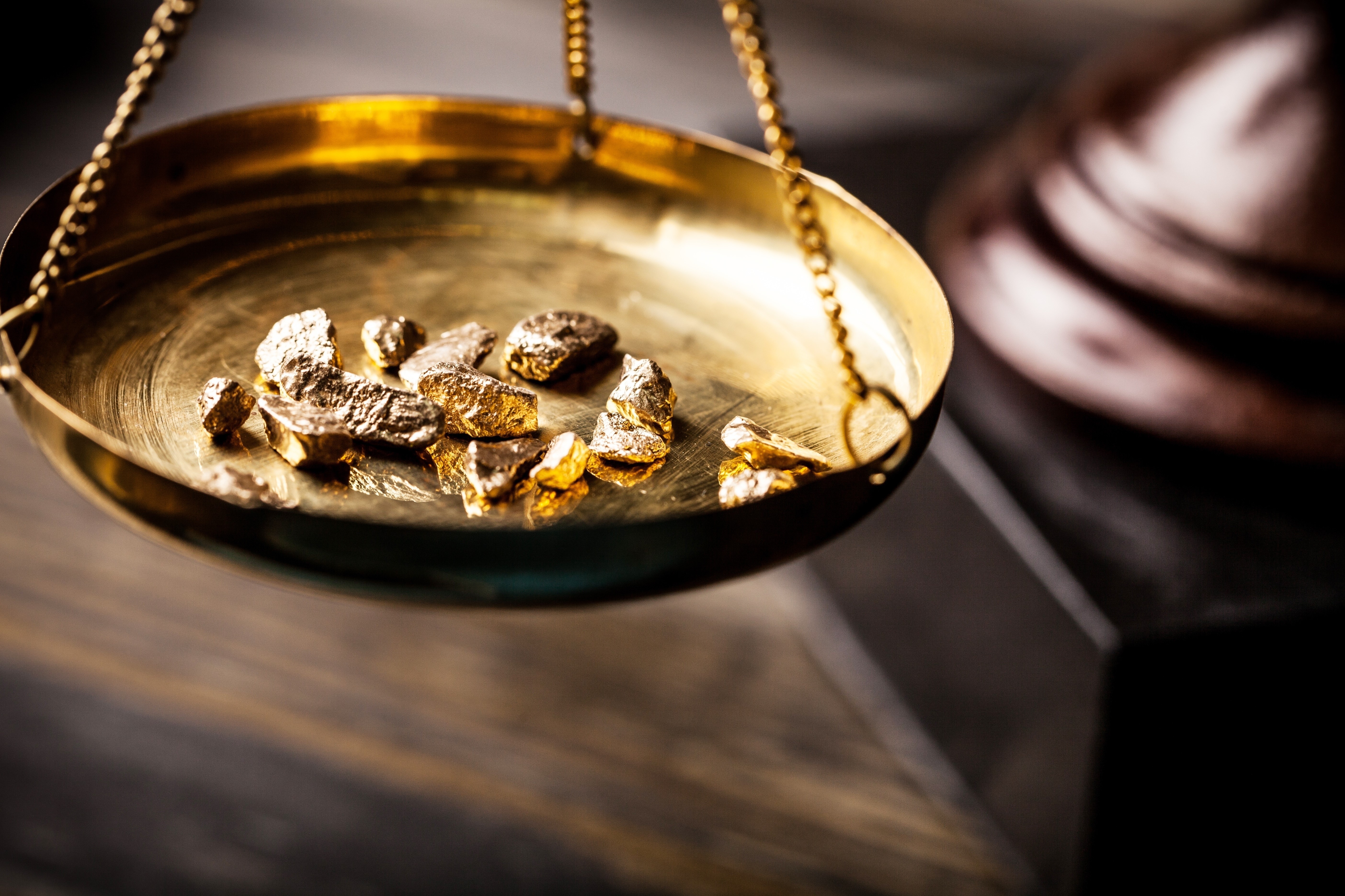 Gold nuggets on a brass scale HD Wallpaper