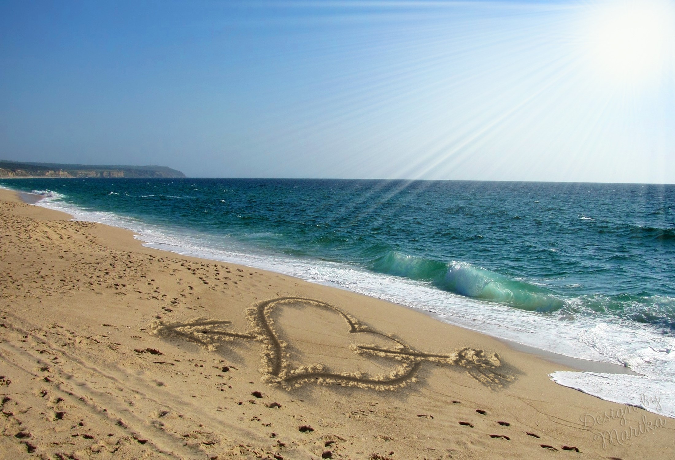Heart with arrow drawn in sand on a beach HD Wallpaper